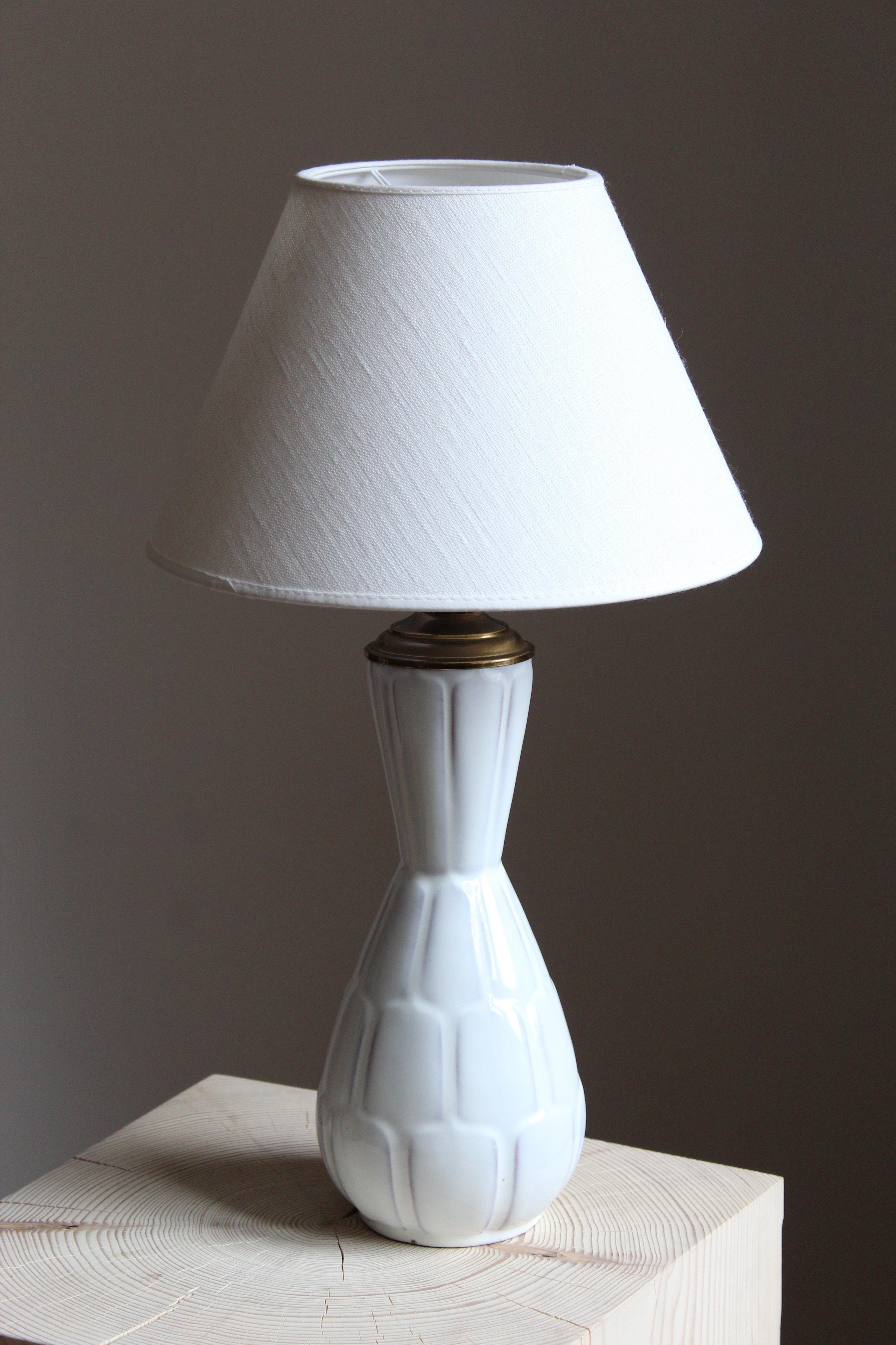 An early modernist table lamp. Designed by Anna-Lisa Thomson, for Upsala-Ekeby, Sweden, 1940s. With stamp including artists initials. Lampshade not included.

Glaze features a white color.

Other designers of the period include Ettore Sottsass, Carl