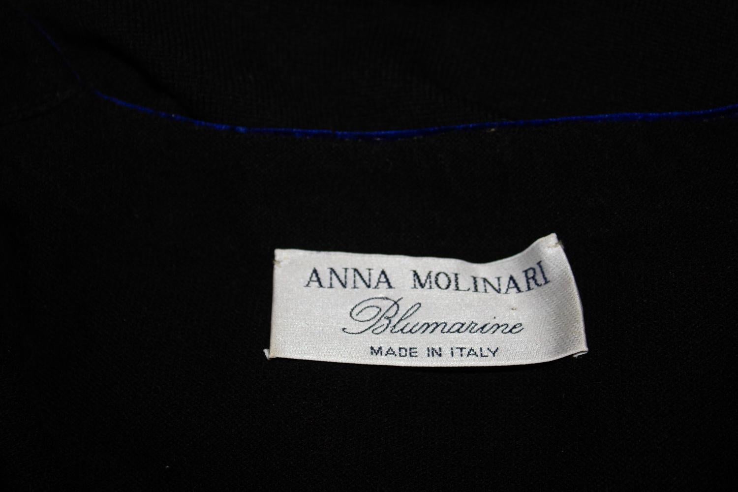 A chic cardigan by Anna Molinari for Blumarine.
The cardigan is in a wool and cashmere mix, with blue velvet trim. it crosses over rather like a ballet cardigan. 
Made in Italy. Size Italian 44 DE 38, Measurements: 
Bust up to 40'', length 19''
