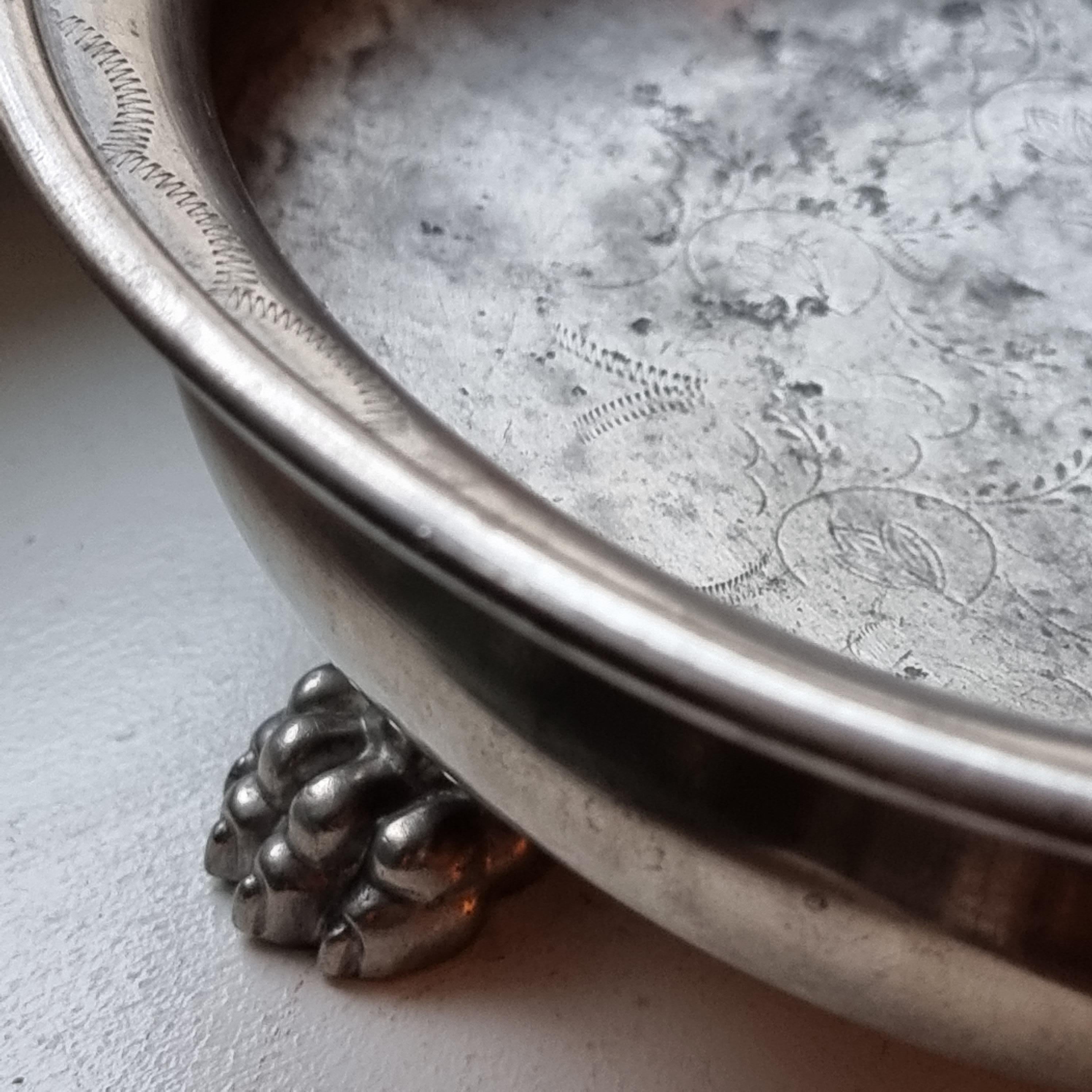 A beautiful solid pewter bowl with lion paws, decor of flowers and leafs. Designed by Anna Petrus for Firma Svenskt Tenn (celebrates 100 years 2024). 

This bowl shows Petrus elegant and timeless style, works perfect as a bowl but decorative as a