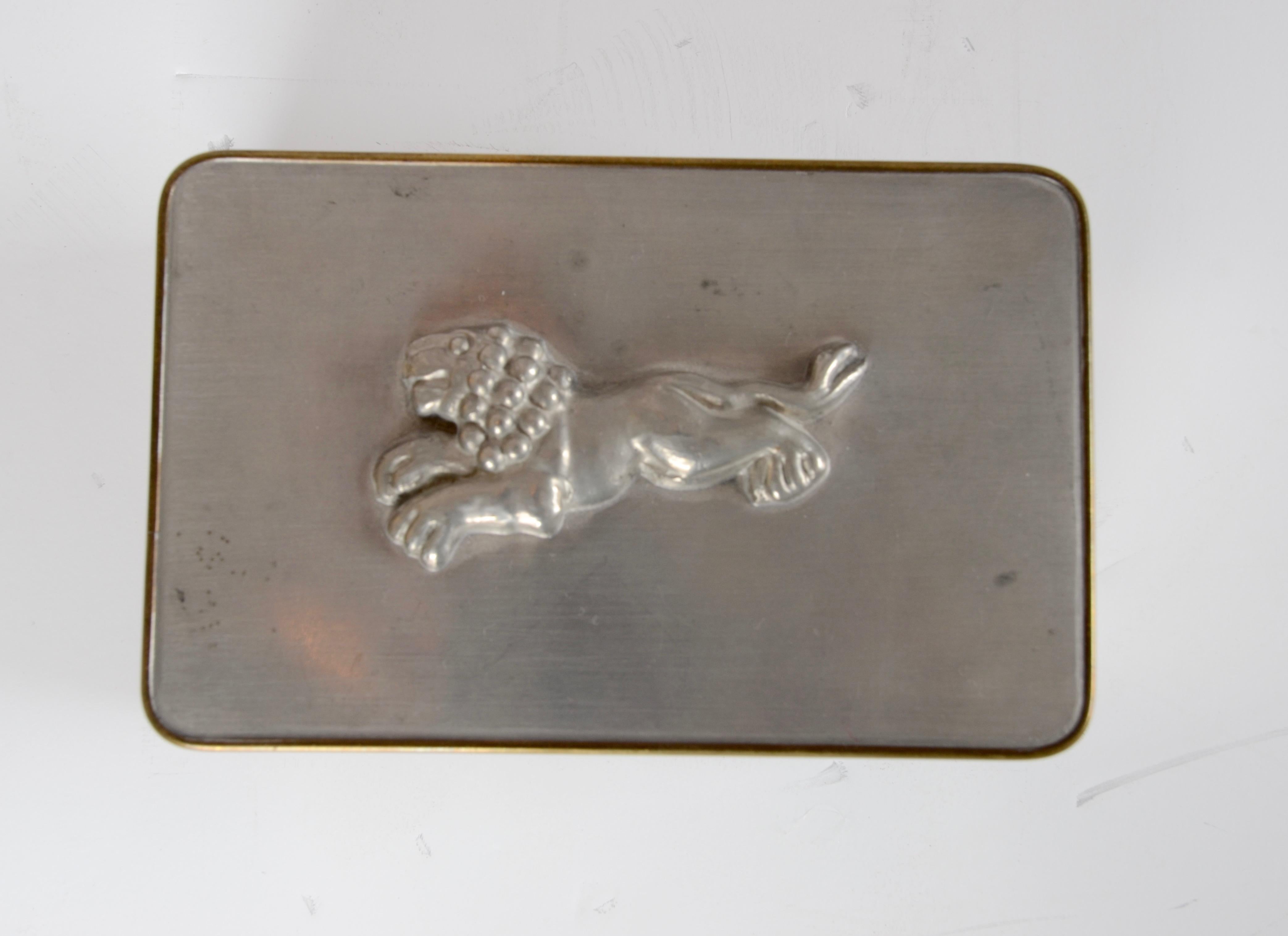 Box with decor of a lion, brass and pewter. Designed by Anna Petrus for Firma Svenskt Tenn. Marked C8 = 1929.
  