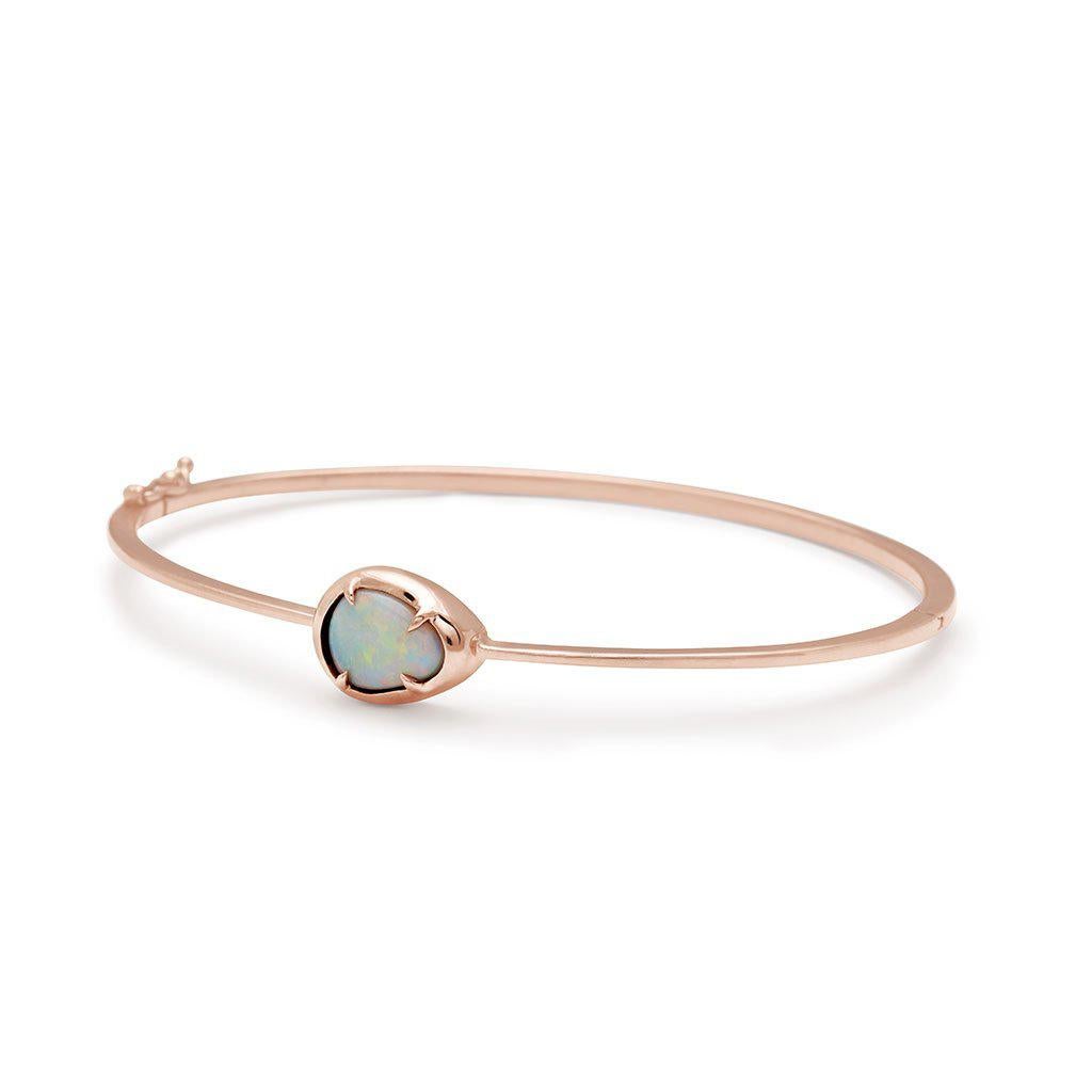 One of a kind opal set in 14k rose gold. One of a Kind.

(Available Now.)

Elegant in its simplicity, this rose gold Amulet bracelet holds a mesmerizing oval opal, held in place by delicate claw prongs. Oval in shape, the bangle fits comfortably on