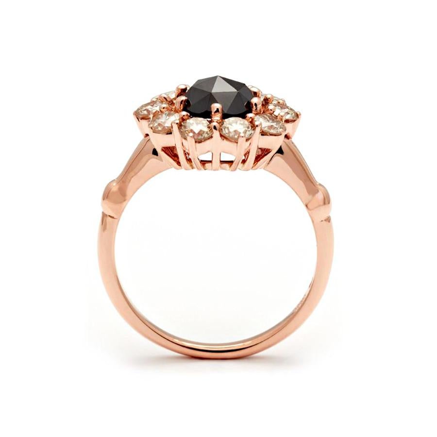 0.95ct round rose cut black diamond center, 1.00ct round champagne diamond halo, set in 14k recycled rose gold.

Black Diamonds are the only treated diamonds we use in our collection and are customarily heated to create their intense black color.

A