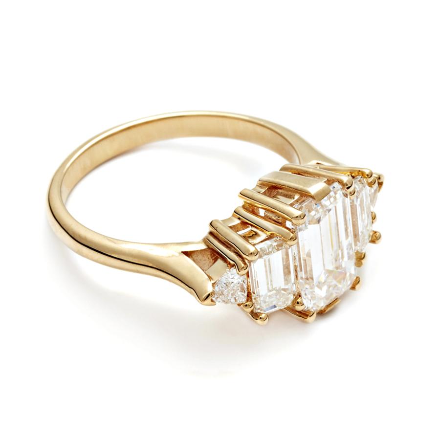 1.50ct (G/VS1) emerald cut white diamond center, 0.94ctw white diamond baguettes, 0.22ctw white diamond side stones, set in 14k recycled yellow gold.

The aptly named Theda Ring is a truly splendorous piece evocative of its namesake, a star of the