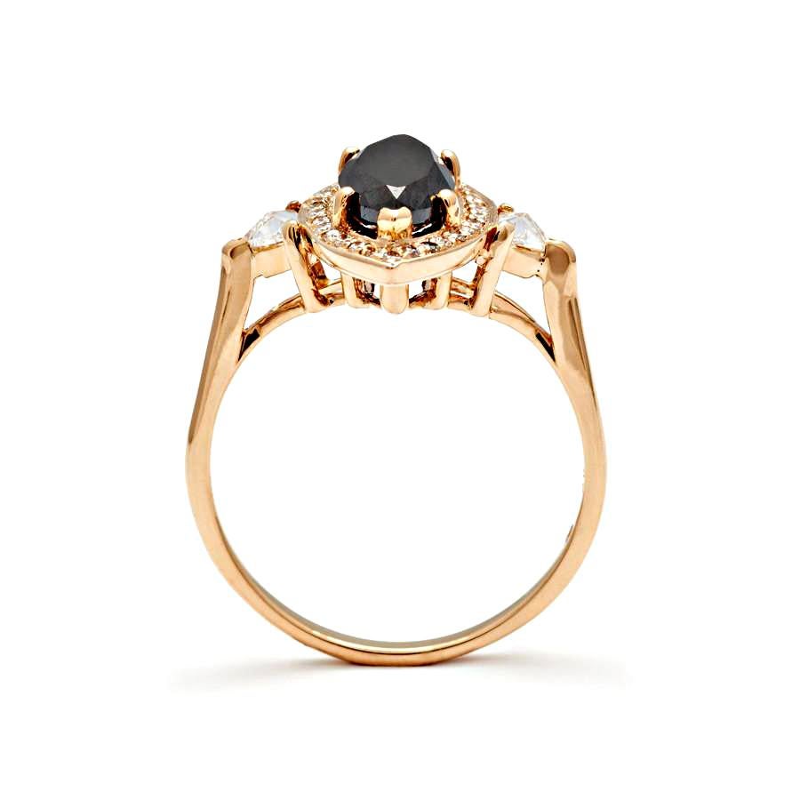 Approximately 2.00ct black marquise diamond center, 0.16ctw white diamond halo with 0.13ct white diamond trillion side stones set in 14k recycled yellow gold.

Black diamonds are the only treated diamonds we use in our collection and are customarily