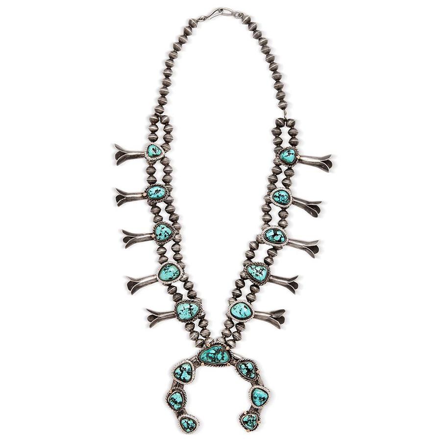 Turquoise set in original sterling silver with 14k yellow gold accents and 0.79ctw grey diamond meleé.

This circa 1980's Squash Blossom necklace is reprised to stunning effect with halos of silver and hand-set white diamond. Unique its scale