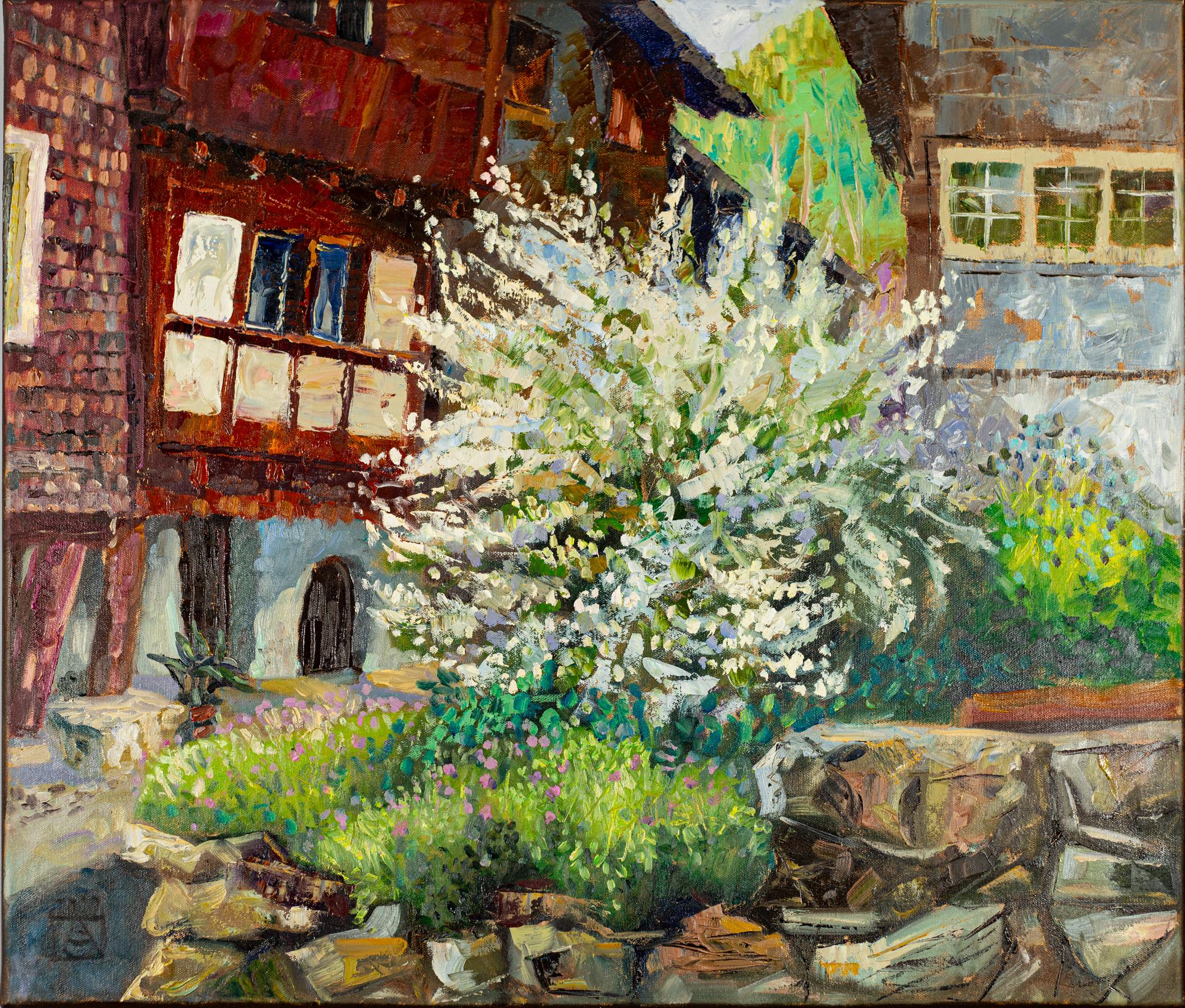 The painting titled "Spring in Werdenberg" is painted in oil on canvas in the style of modern impressionism and depicts a picturesque corner of the medieval town of Werdenberg in Switzerland. In the foreground is a lush white bush symbolizing the