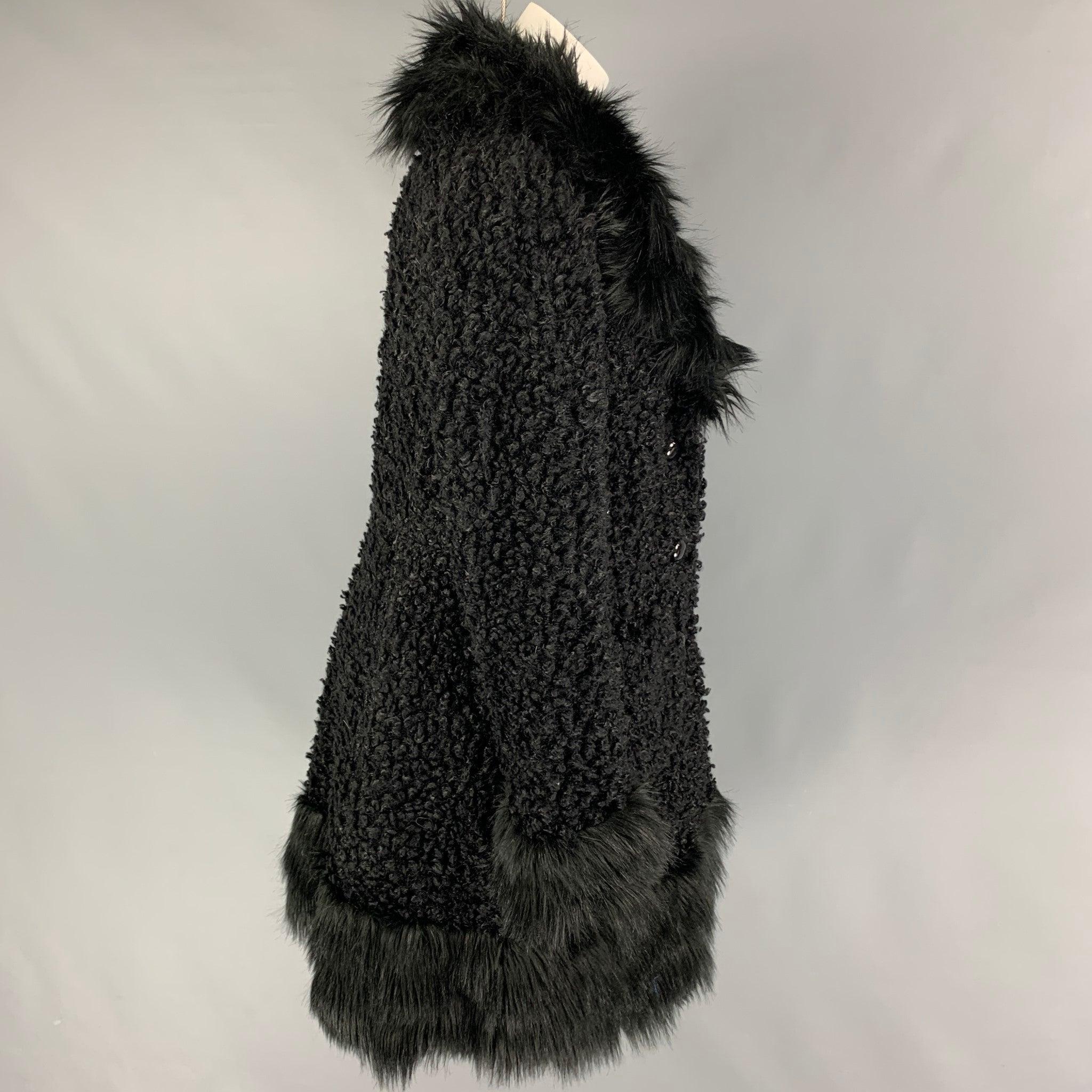 ANNA SUI coat comes in a black textured faux fur featuring a large collar design, patch pockets, and a buttoned closure. Made in USA.
Very Good
Pre-Owned Condition. 

Marked:   M 

Measurements: 
 
Shoulder: 16 inches  Bust: 40 inches  Sleeve: 25