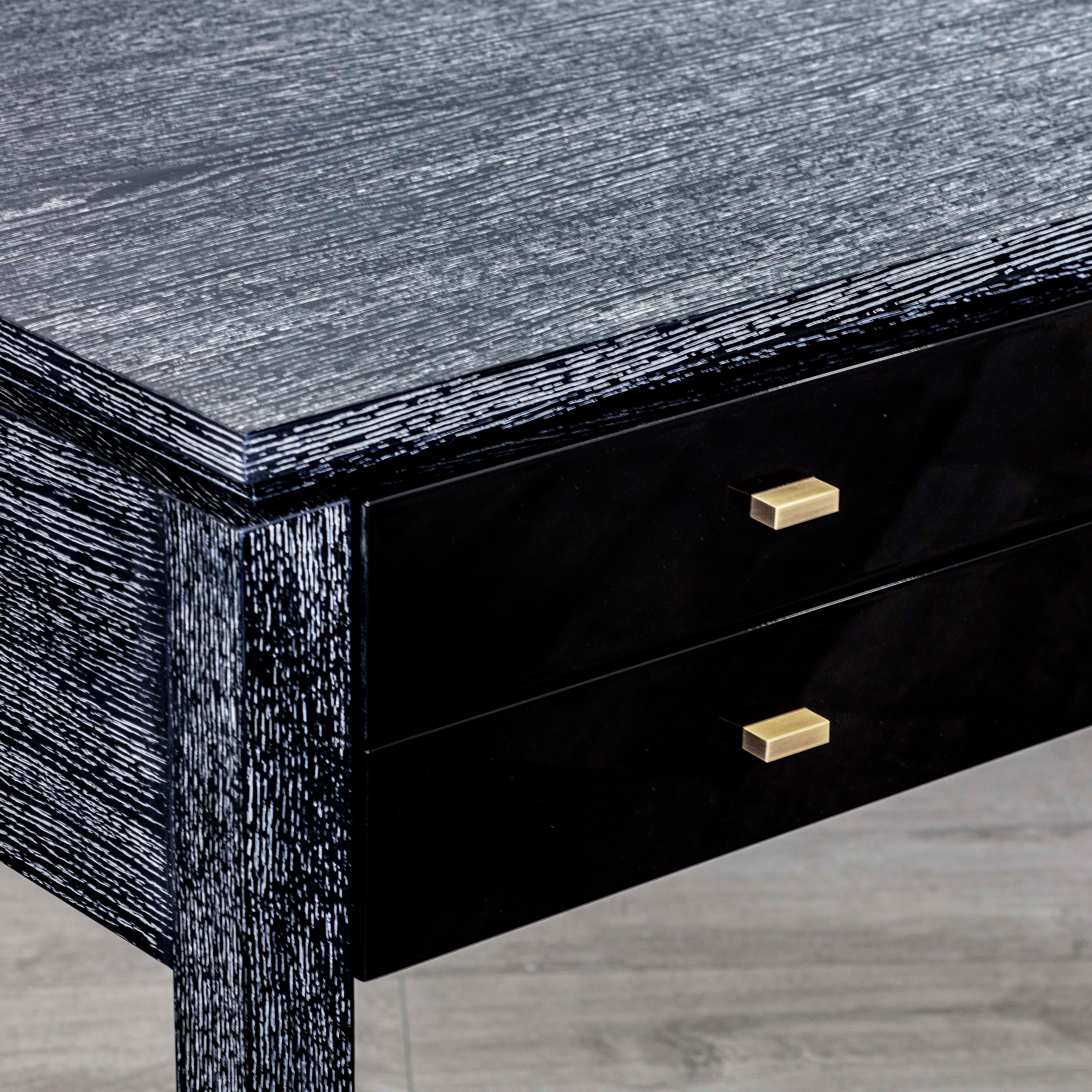 Anna desk is an imposing and elegant writing desk. With a high gloss lacquered body that contrasts with the brushed oak top and feet with lime finish. The delicate brass details add character and beauty to this piece.

Shown in black limed oak top
