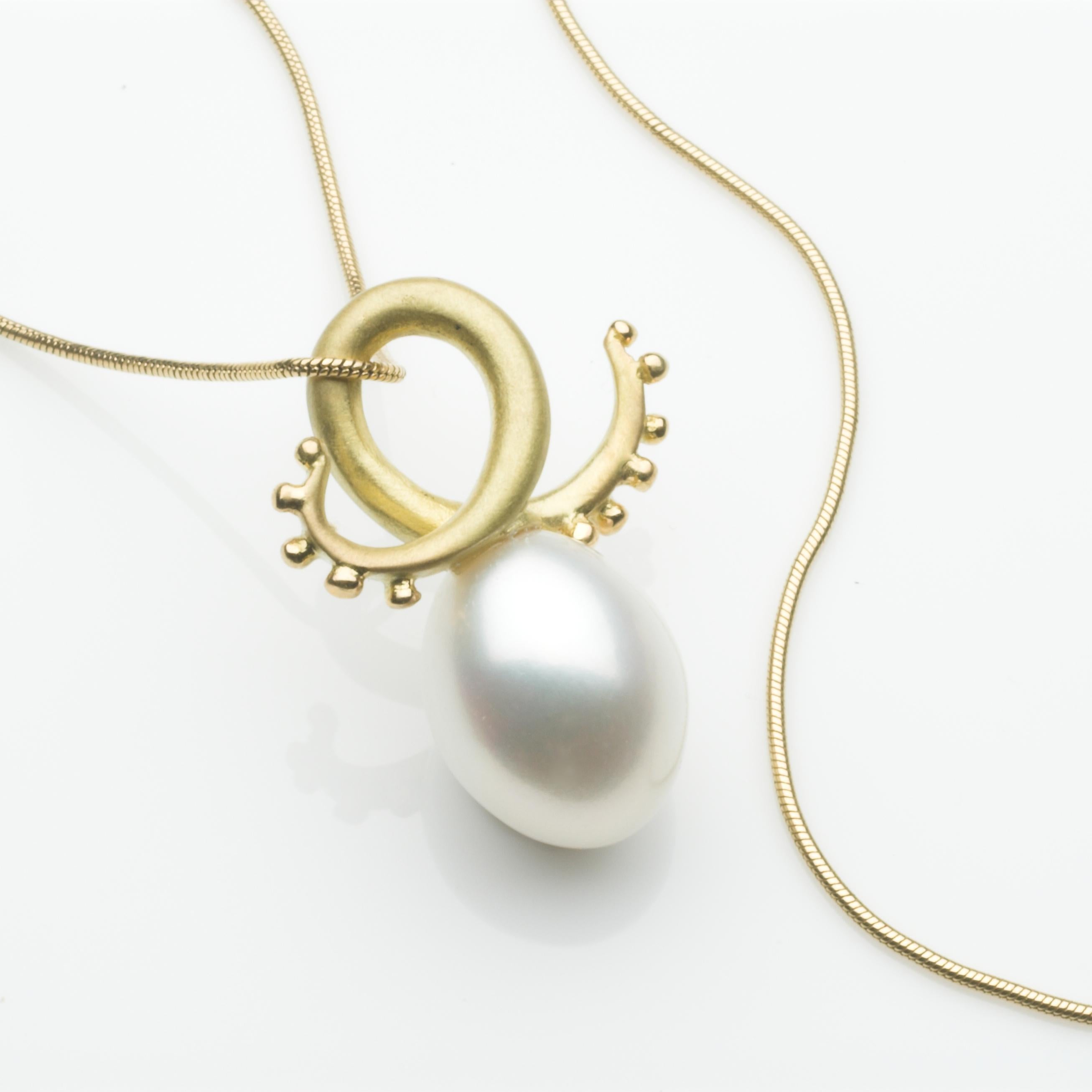 Tentacle pendant in 18ct yellow gold, set with a white freshwater drop pearl. This beautiful and versatile pendant comes on a black leather cord, alternatively it can be ordered with a chain. Chains are sold as a separate item, such as the 18