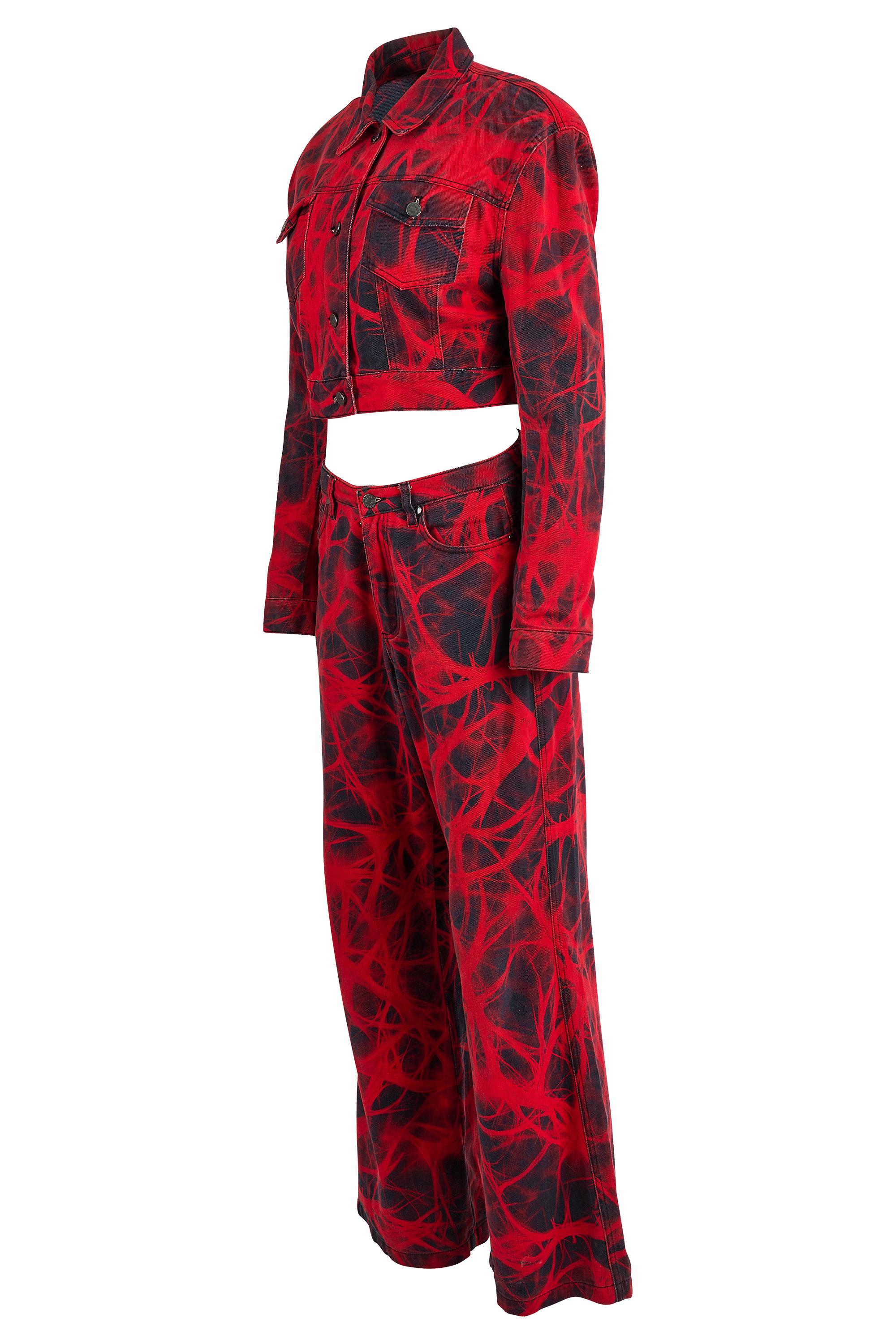 Annakiki denim Co-ord set. This set features a cropped jacket with button up details, a traditional detail for a denim jacket, with a leather badge on the back neckline that has the brand tag. The trousers are more of a baggy fit, which can be worn