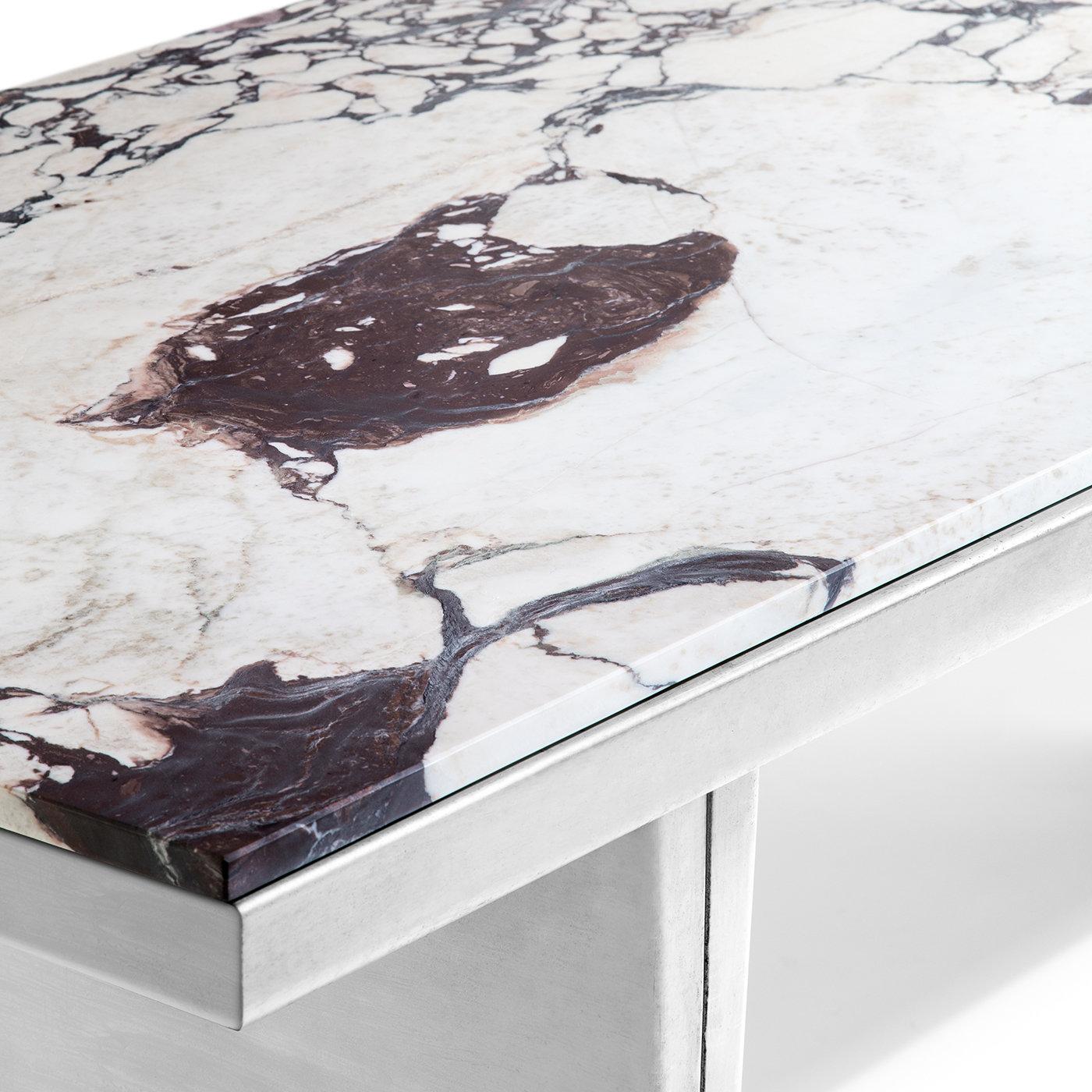 This stately dining table was designed for Unipol specifically for the inauguration of the 2019 Salone Del Mobile furniture exhibition at the Velasca tower. Defined by a striking tabletop in white marble with dense, dark veining, the sturdy and