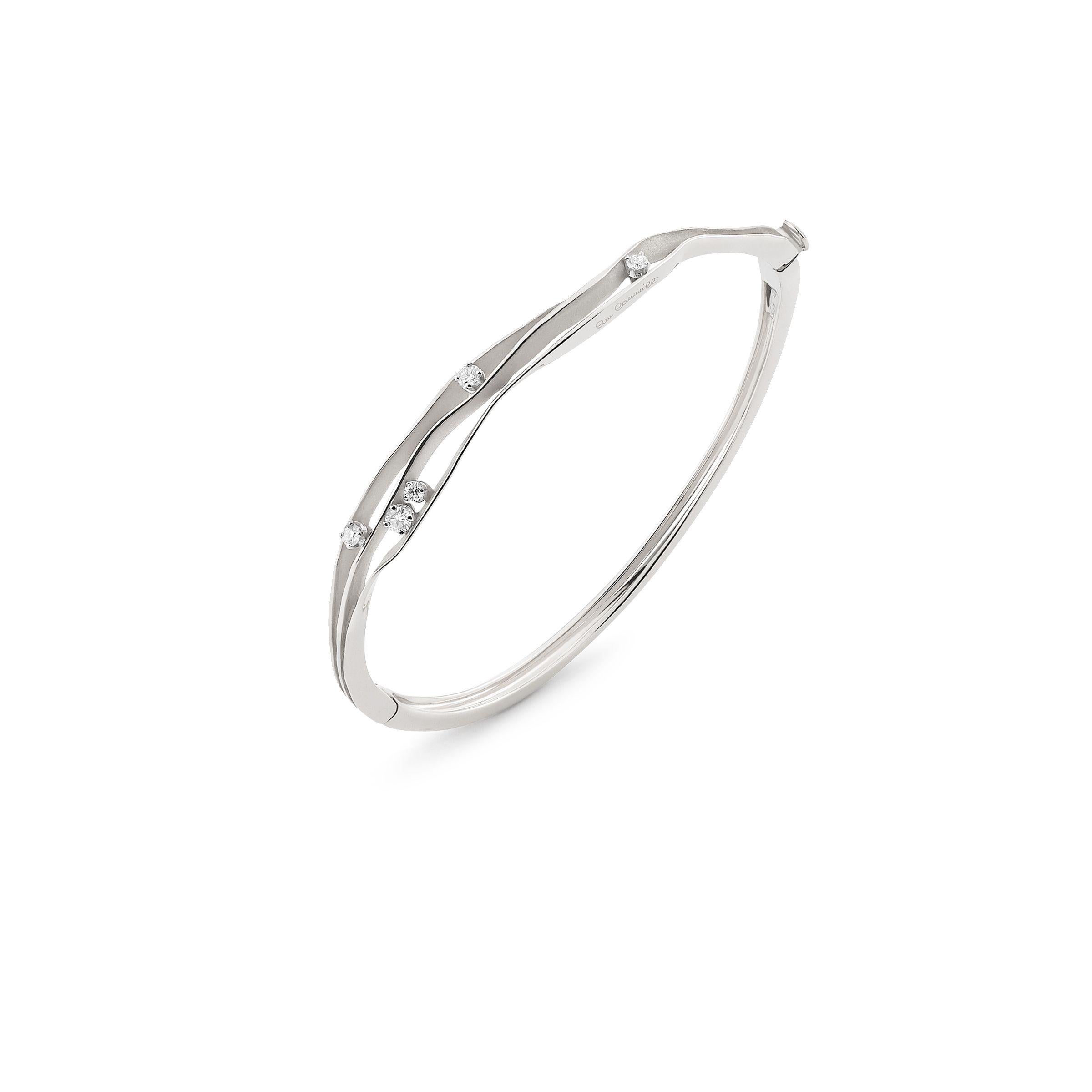 From Annamaria Cammilli's Essential collection, Dune bracelet handcrafted in 18 karat Ice White gold. Five brilliant white diamonds at 0.31 carat total weight are prong set and nested in four curving layers of satin and polished gold. 8 mm wide at