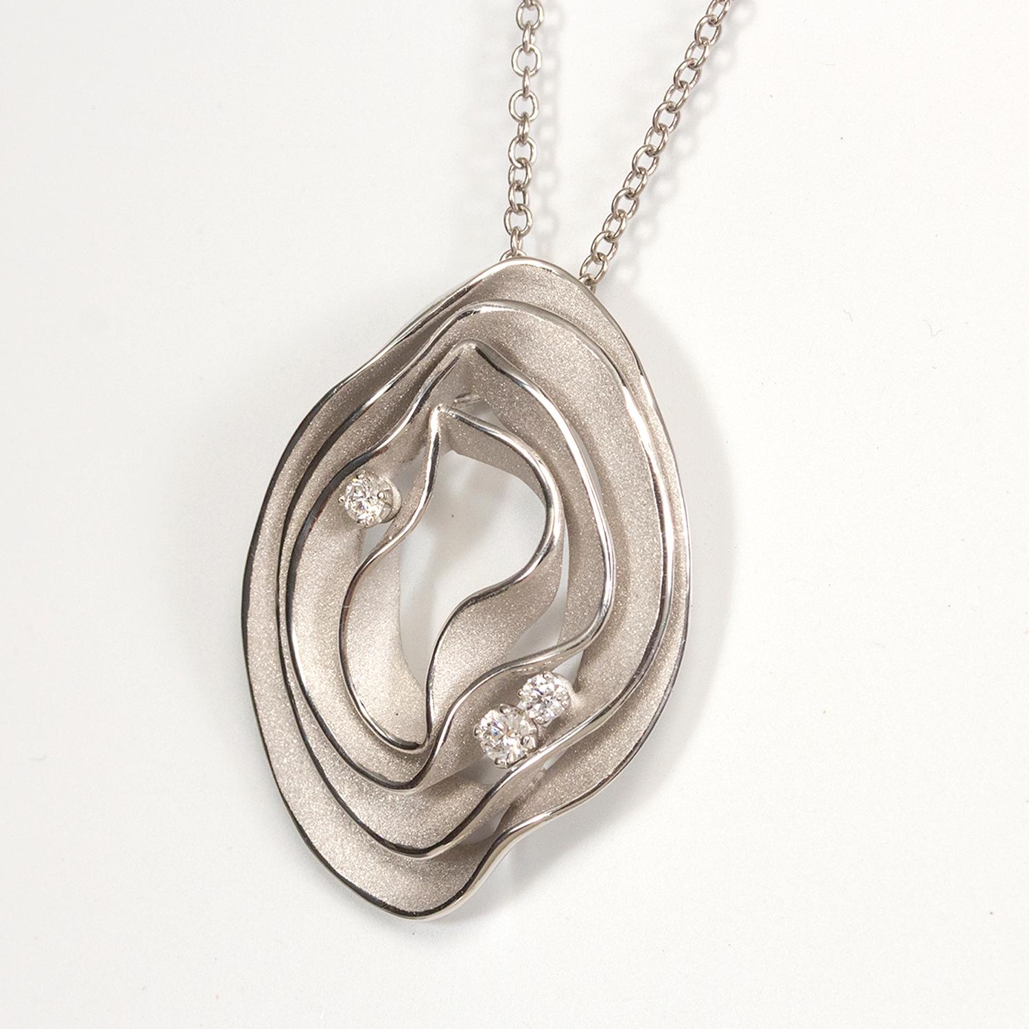 From Annamaria Cammilli's Dune Electa collection, pendant necklace handcrafted in 18 karat Ice White gold. Four layers of polished and satin textured gold, with three diamonds nested between layers. Diamond total weight is 0.16 carat. Pendant