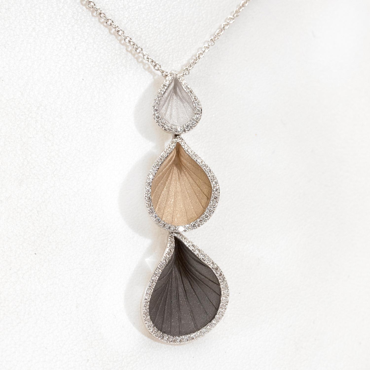 From Annamaria Cammilli's Vision collection, three drop Goccia pendant necklace handcrafted in 18 karat Black Lava, Natural Beige and White Ice gold. Three teardrop shaped petals in white, beige and black gold are outlined with white bead set