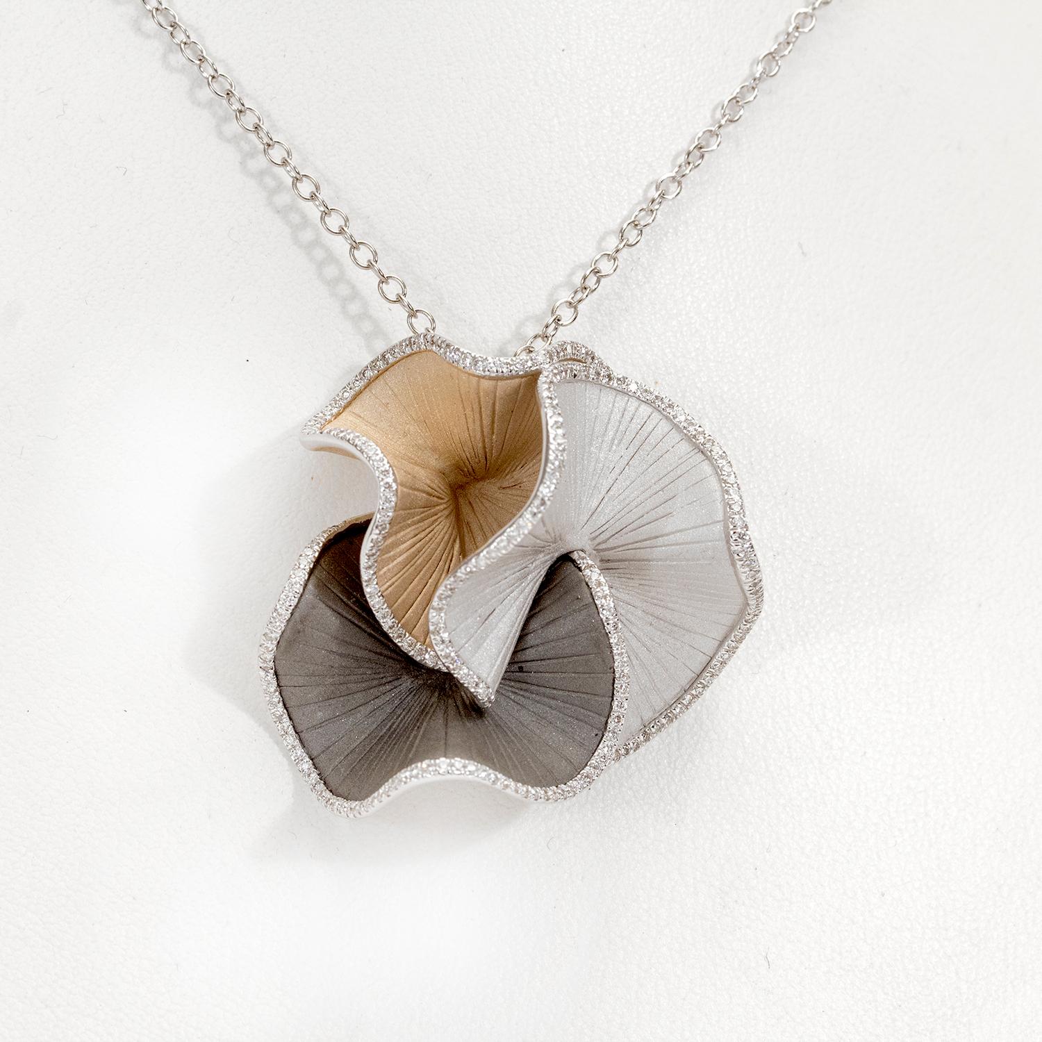 From Annamaria Cammilli's Vision collection, medium size Sultana pendant necklace handcrafted in 18 karat Black Lava, Natural Beige and White Ice gold. Three ruffles in white, beige and black gold are clustered together with bead set white diamonds