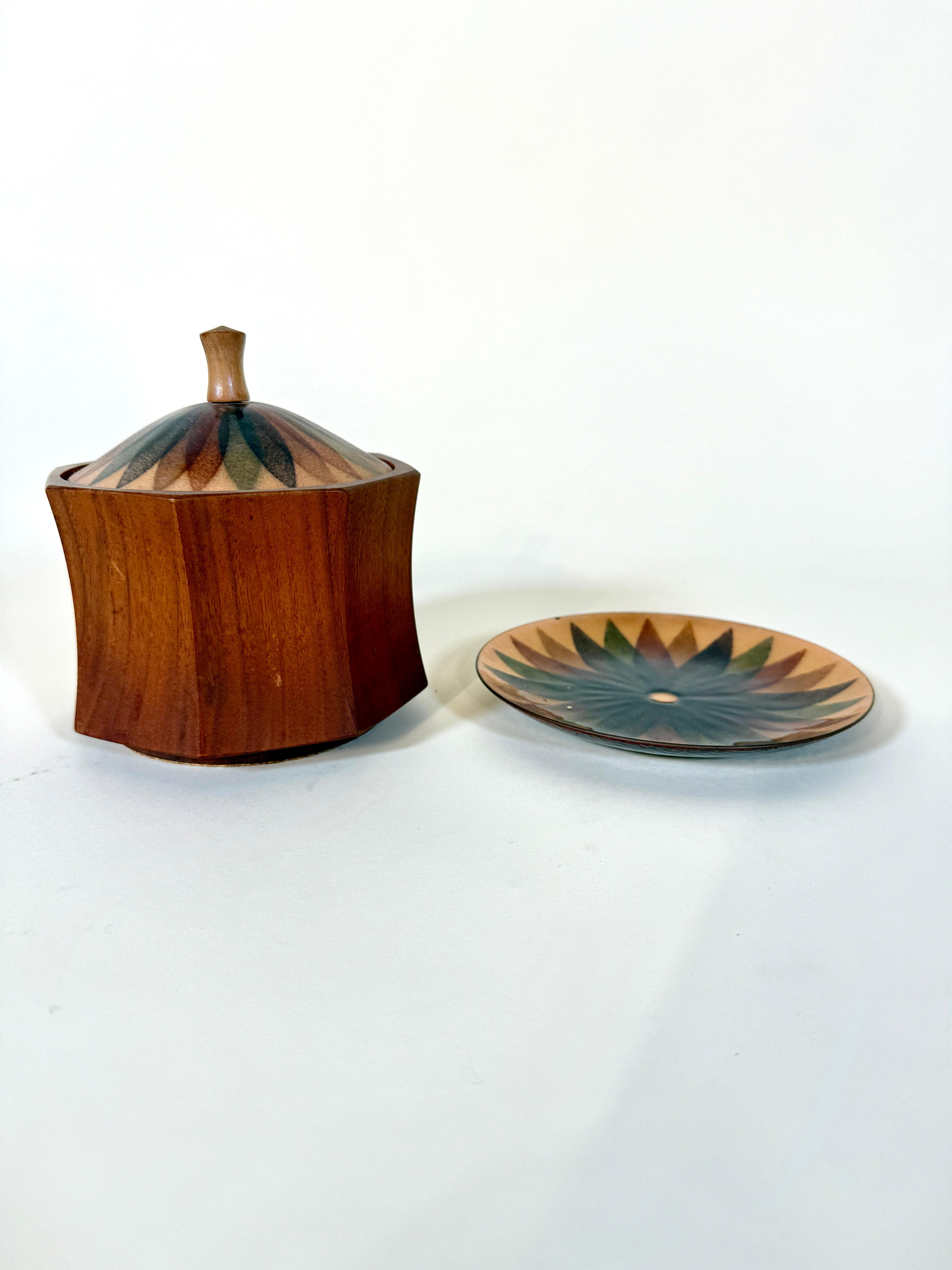 A stunning Mid-Century Modern studio craft set by acclaimed California artist Annamarie Davidson, featuring a hand-enameled copper plate and matching lidded wood bowl. Known for her richly colored, abstract enamel work, Davidson’s pieces are highly