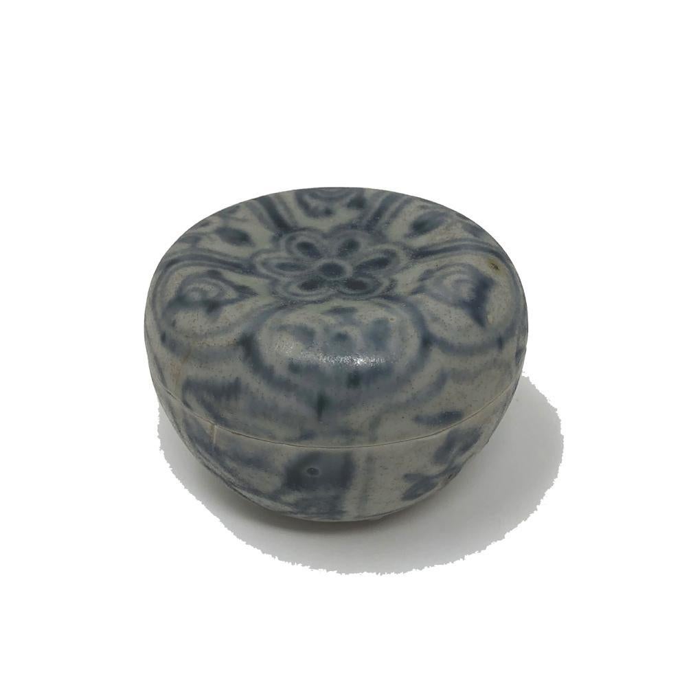 Annamese Blue and White Ceramic Box, Chu Dau kiln, Vietnam, circa 1500. A globular form with concave depression on center of the flat lid, decorated with flower blossom on center surrounded by petals and lappets alternating with tendrils and water