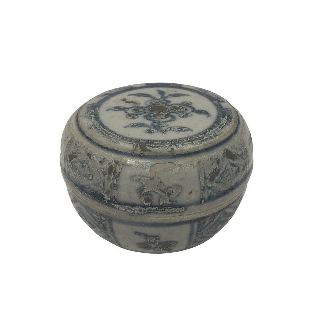 Annamese Blue and White Ceramic Box, Chu Dau kiln, Vietnam, circa 1500. A circular form with flat top, decorated in a stylized floral spray on center, framed by a band of water plants, the sides of both the cover and the base having alternating