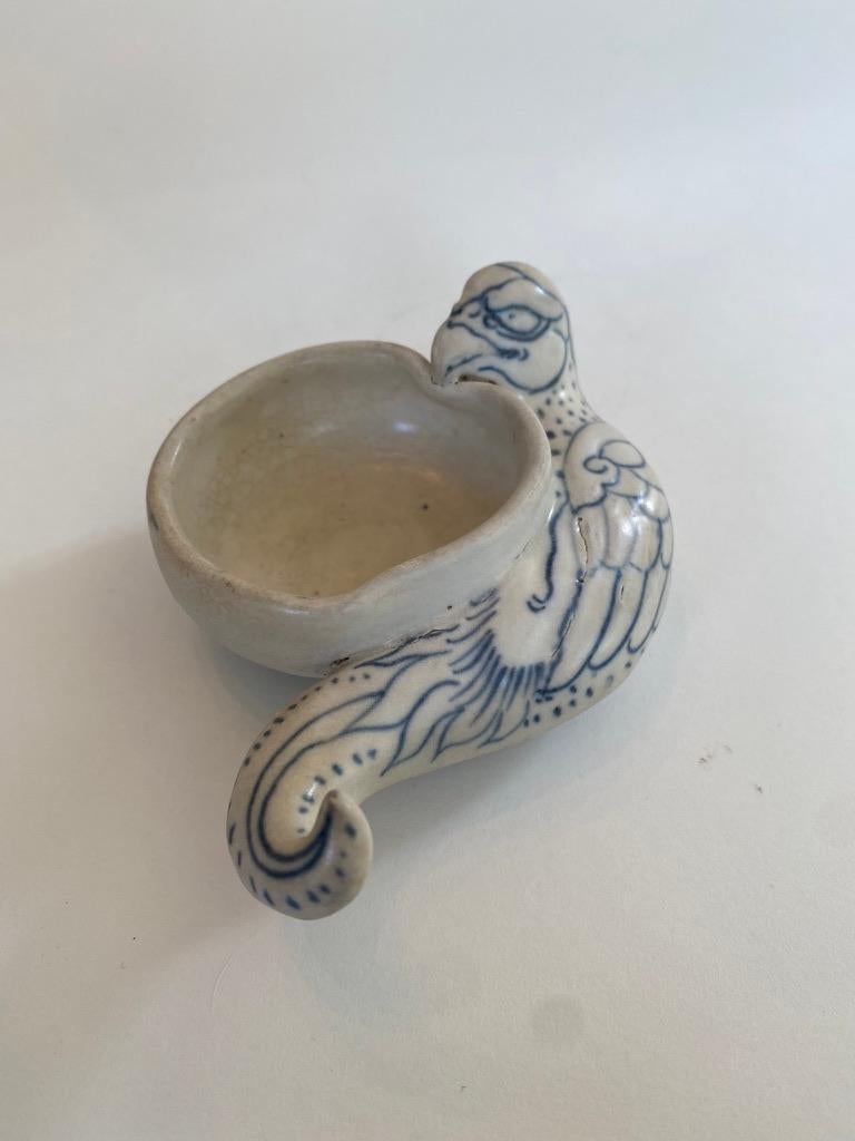 Blue and white Annamese porcelain brush washer encircled by a parrot. Recovered from the wreck of a 15th century ship off the coast of Hoi An, among a group of sunken porcelain known as the Hoi An Hoard, found 230 feet below the surface of the