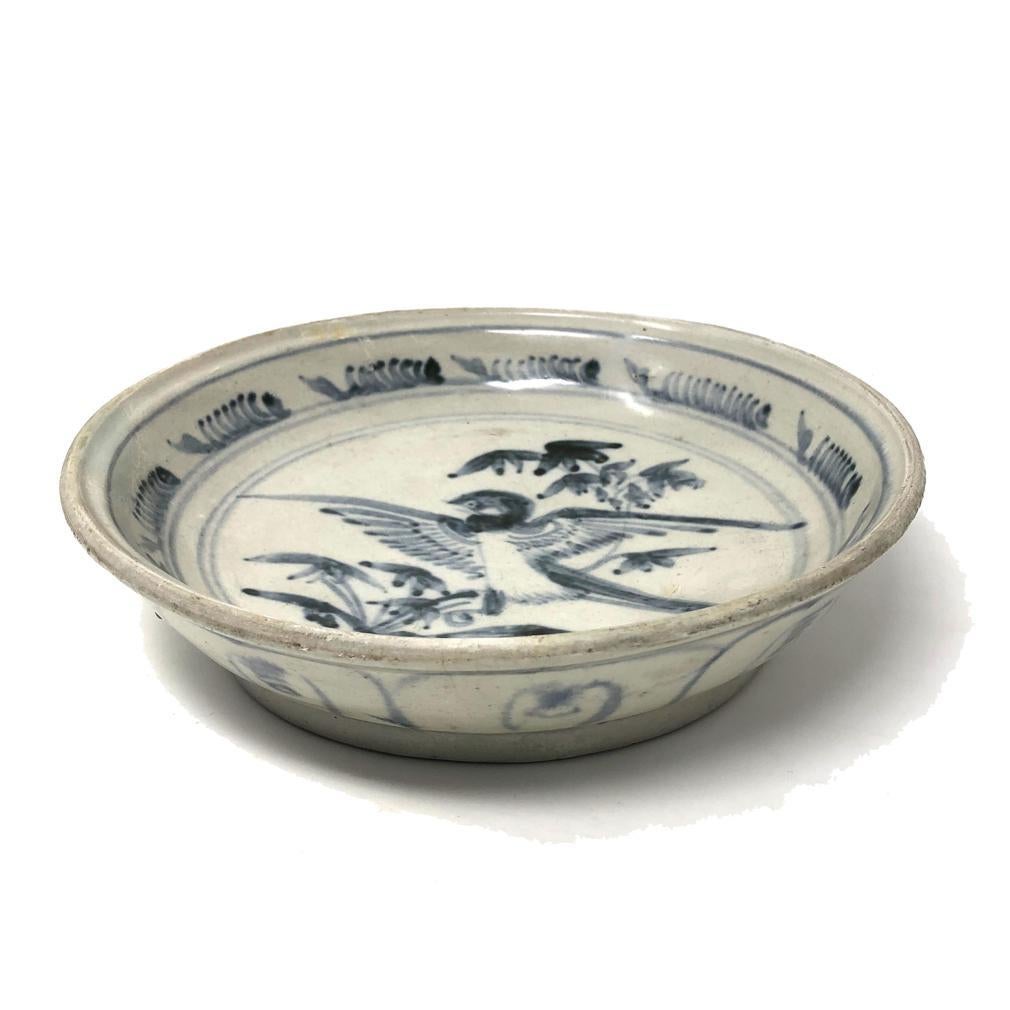 Annamese Blue and White Ceramic Dish, Bird Design, Chu Dau kiln, Vietnam, circa 1500. Stoneware with raised rim decorated in under glaze cobalt blue of a plump bird with wings outstretched, perched on a leafy bamboo branch on center, surrounded by a