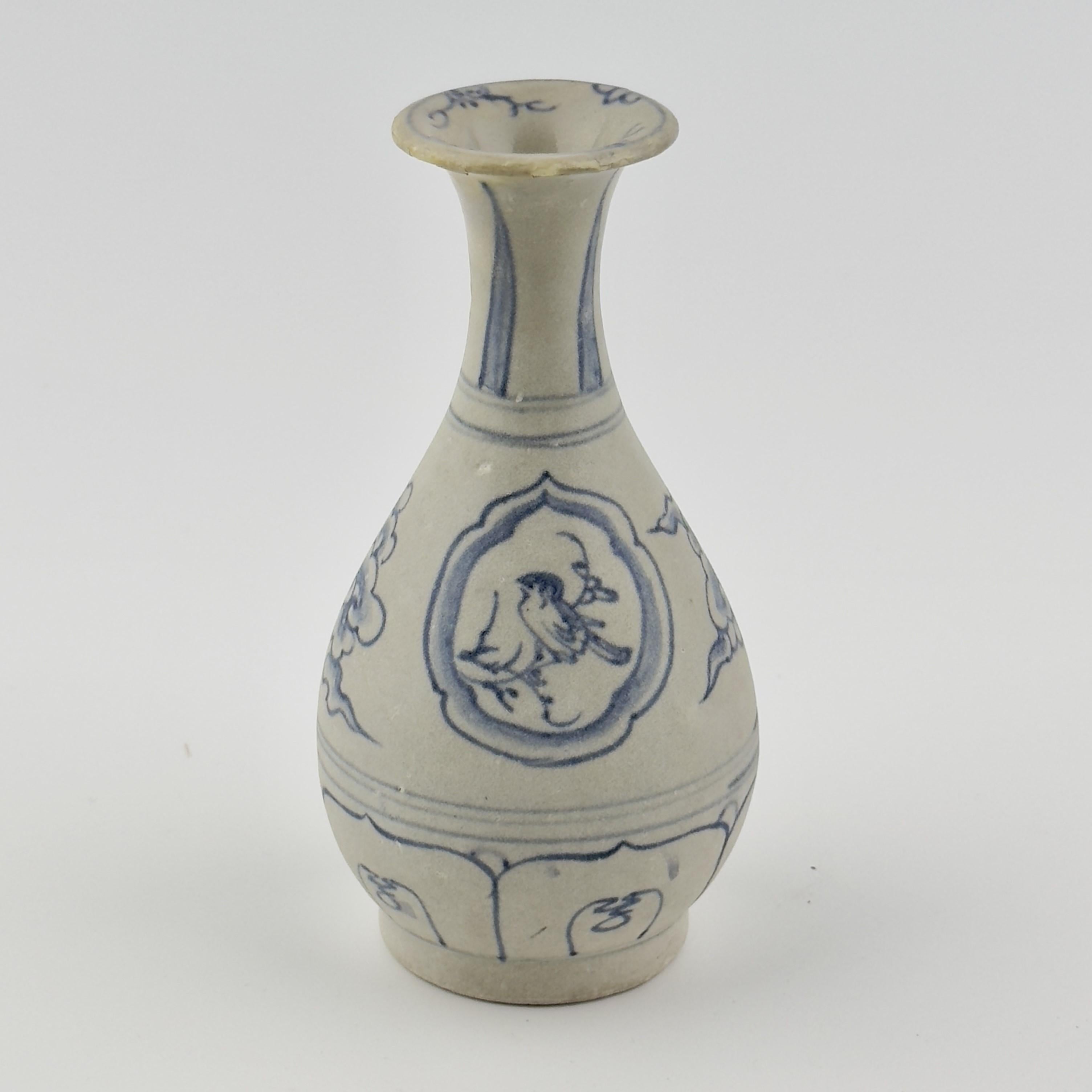 At the center of the vase, within a rounded frame, a bird is depicted perched on a small branch. The bird’s feathers and body are finely detailed, while the beak and eyes are rendered simply but clearly, conveying a sense of calm and serenity.

The