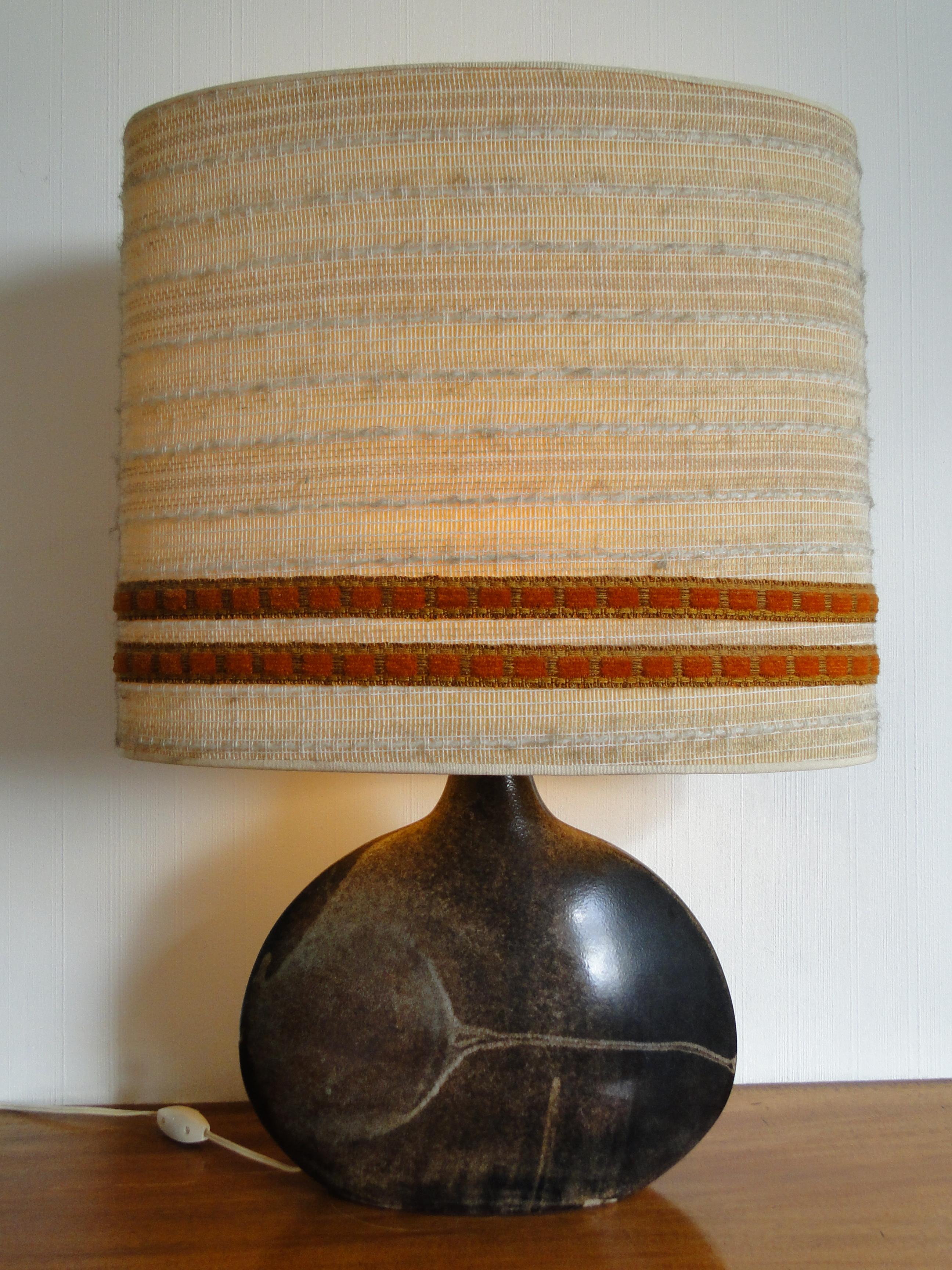 Anne and Pierre Roset Ceramic Table  Lamp Monteyroux France 1950

Beautiful ceramic lamp with its original lampshade and signed under the lamp. 

Height 70 cm  Width 51 cm 

Dimensions of the ceramic:  Height 30 cm Width 36 cm 

The lamp will be