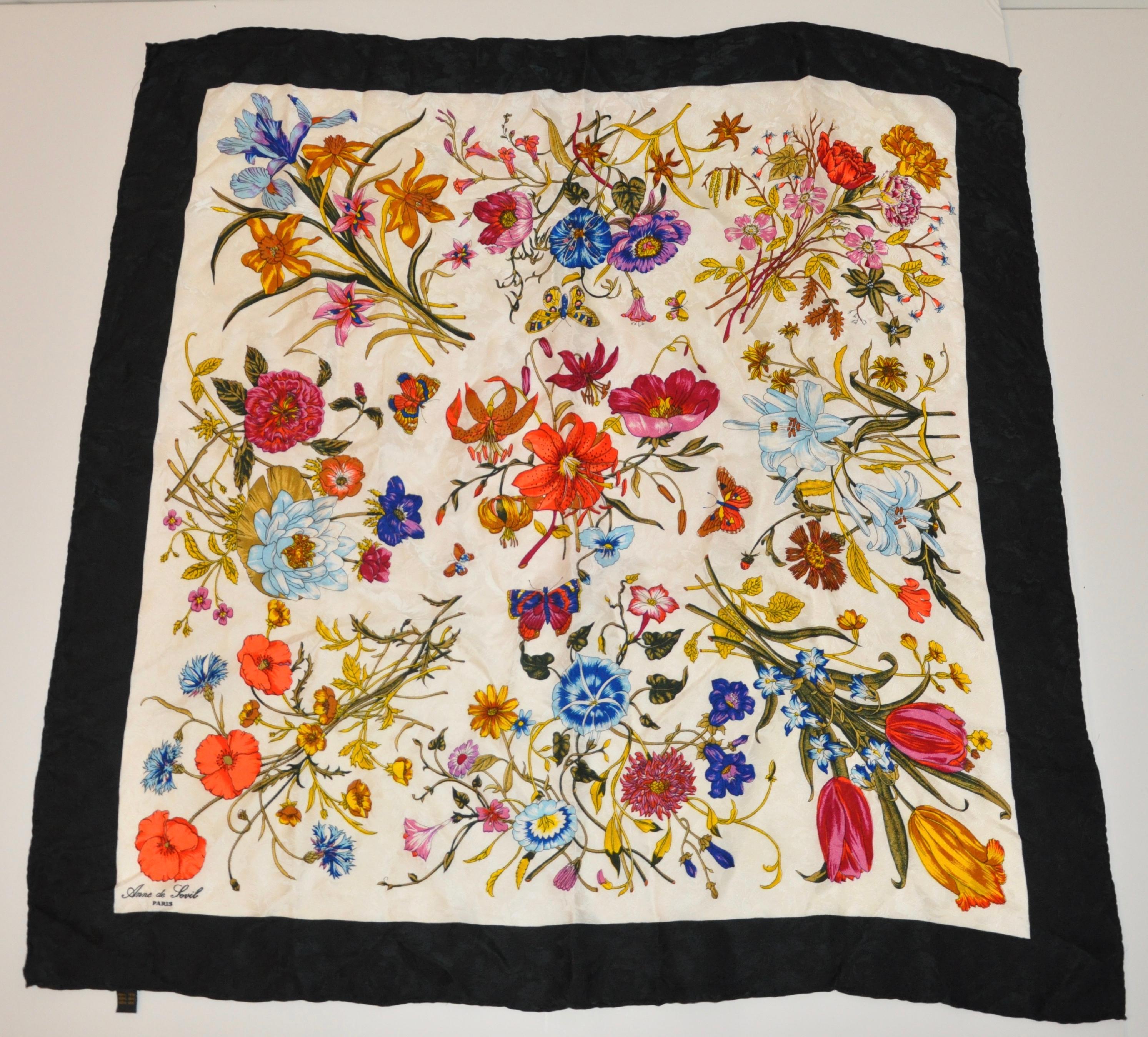      Anne de Levil, of Paris, wonderfully elegant detailed bold multicolor Florals and Butterflies silk scarf is completed with hand-rolled black borders. This scarf measures 33 inches by 33 and a half inches. Made in France. 