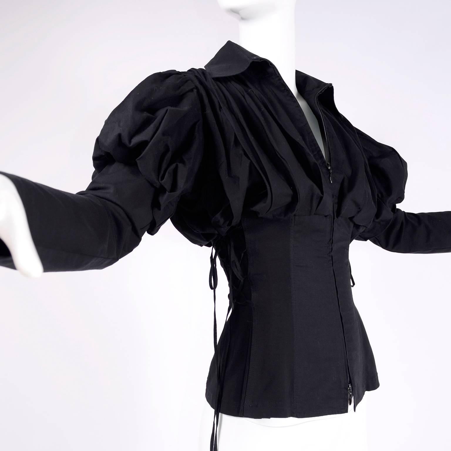 This rare style  Anne Fontaine Blouse is in a rich black pima cotton with gorgeous leg of mutton sleeves and dramatic laces on the sides. The blouse is styled like a Victorian corset with stays and a fitted waist and it has hooks and eyes for