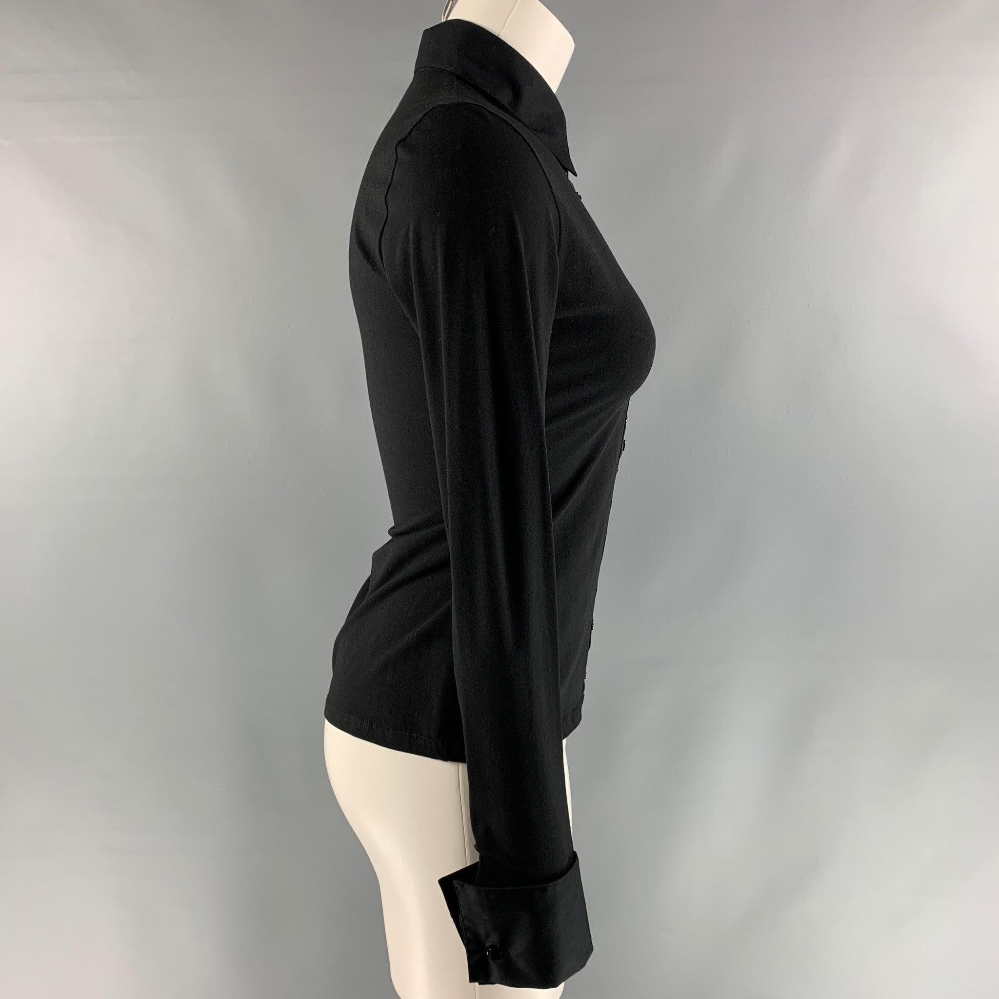 ANNE FONTAINE long sleeve blouse comes in black cotton and elastane fabric, straight collar, ribbon hock and eye closure and square french cuff.
 Very Good Pre-Owned Condition. Washable Marks at cuff and shoulder. 
 

 Marked:  38 
 

 Measurements: