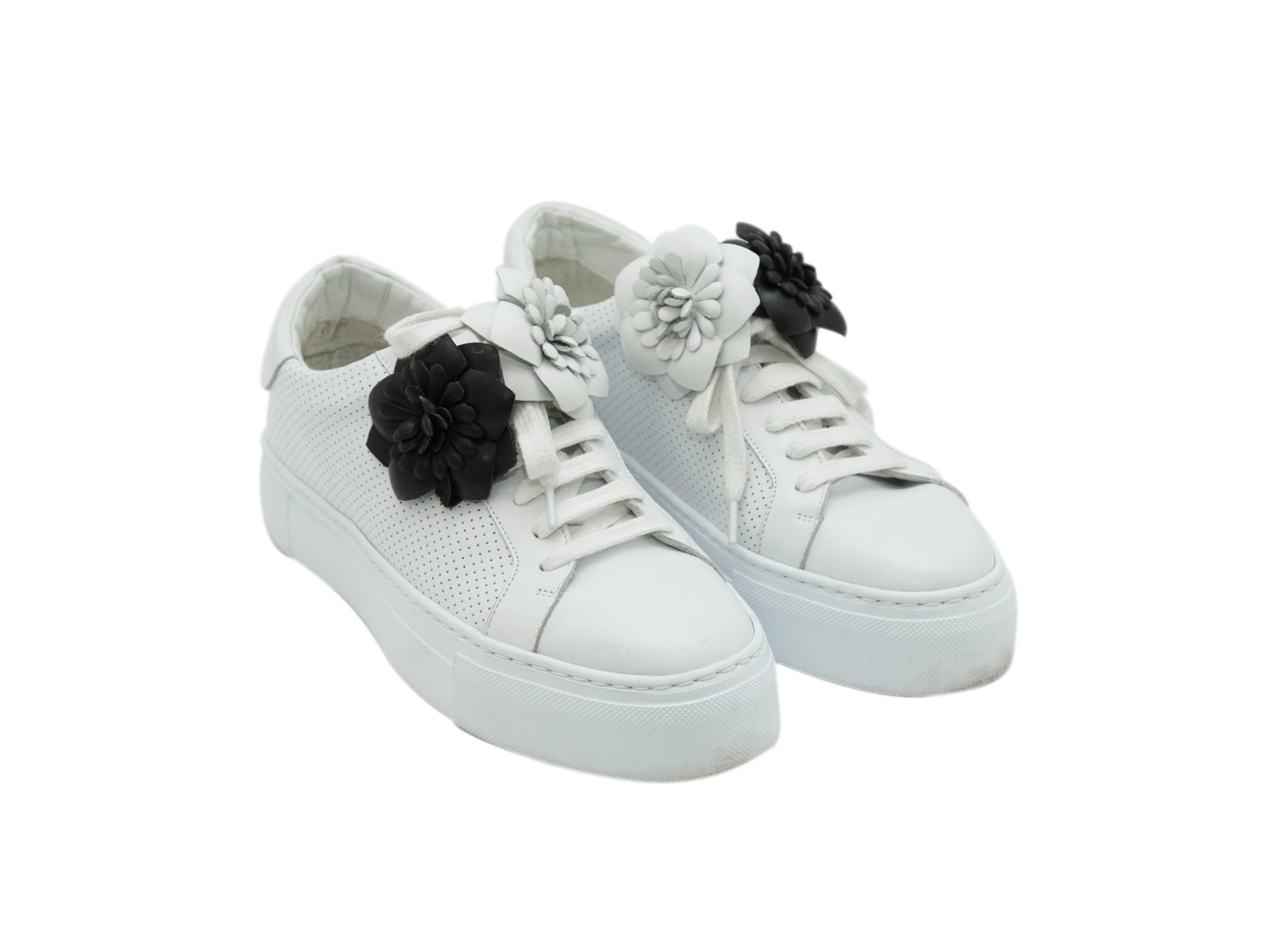 Product details: White perforated leather platform sneakers by Anne Fontaine. Round-toes. Black and white rosette accents at vamps. Tie closure at tops. 1.5