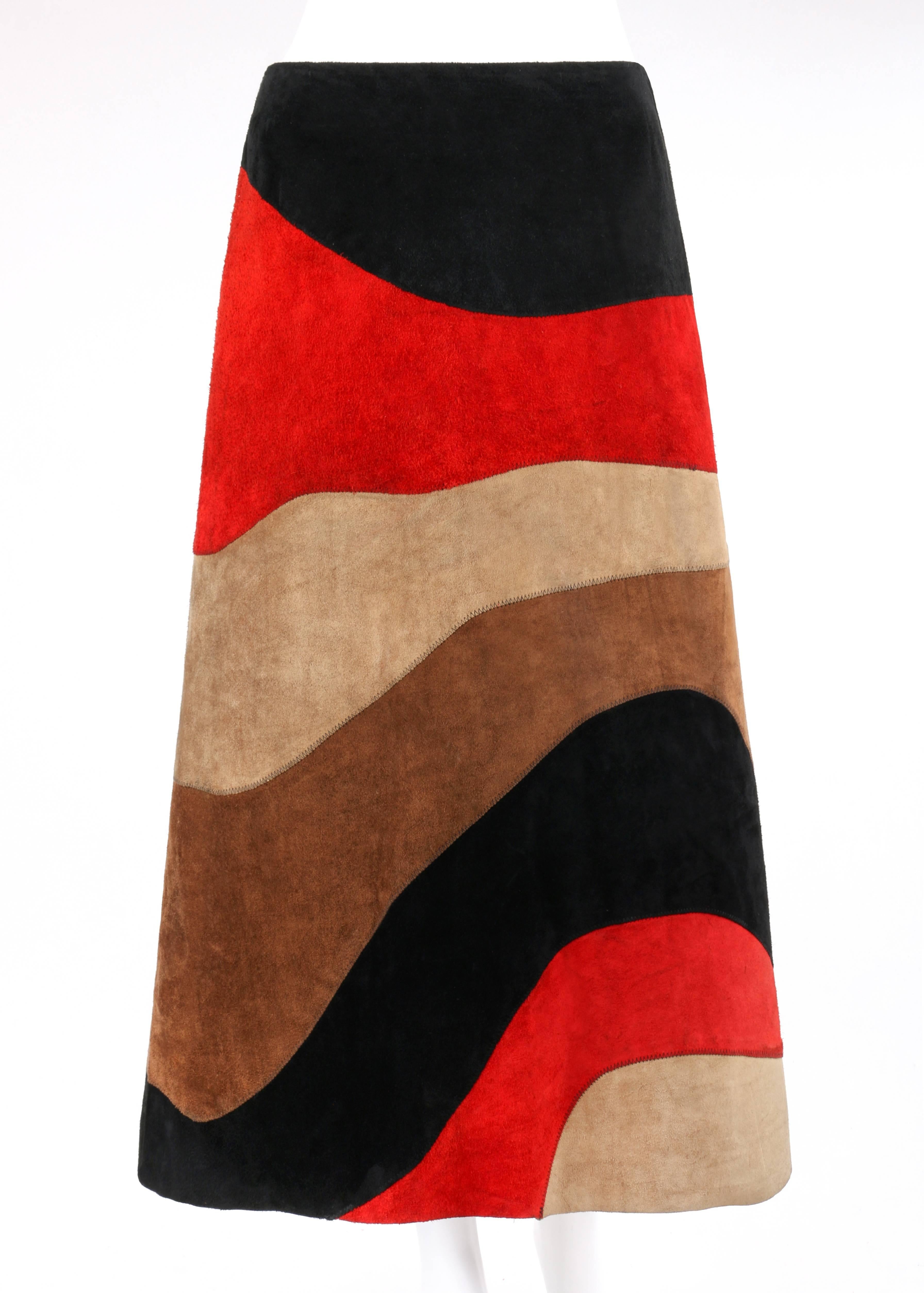 Vintage Anne Klein c.1970's red black brown color block suede leather a-line skirt. Designed by Donna Karan. Color-blocked wave pattern suede leather in shades of black, red, beige, and brown. Zig-zag overlay stitch detail throughout. Raw-edge hem.