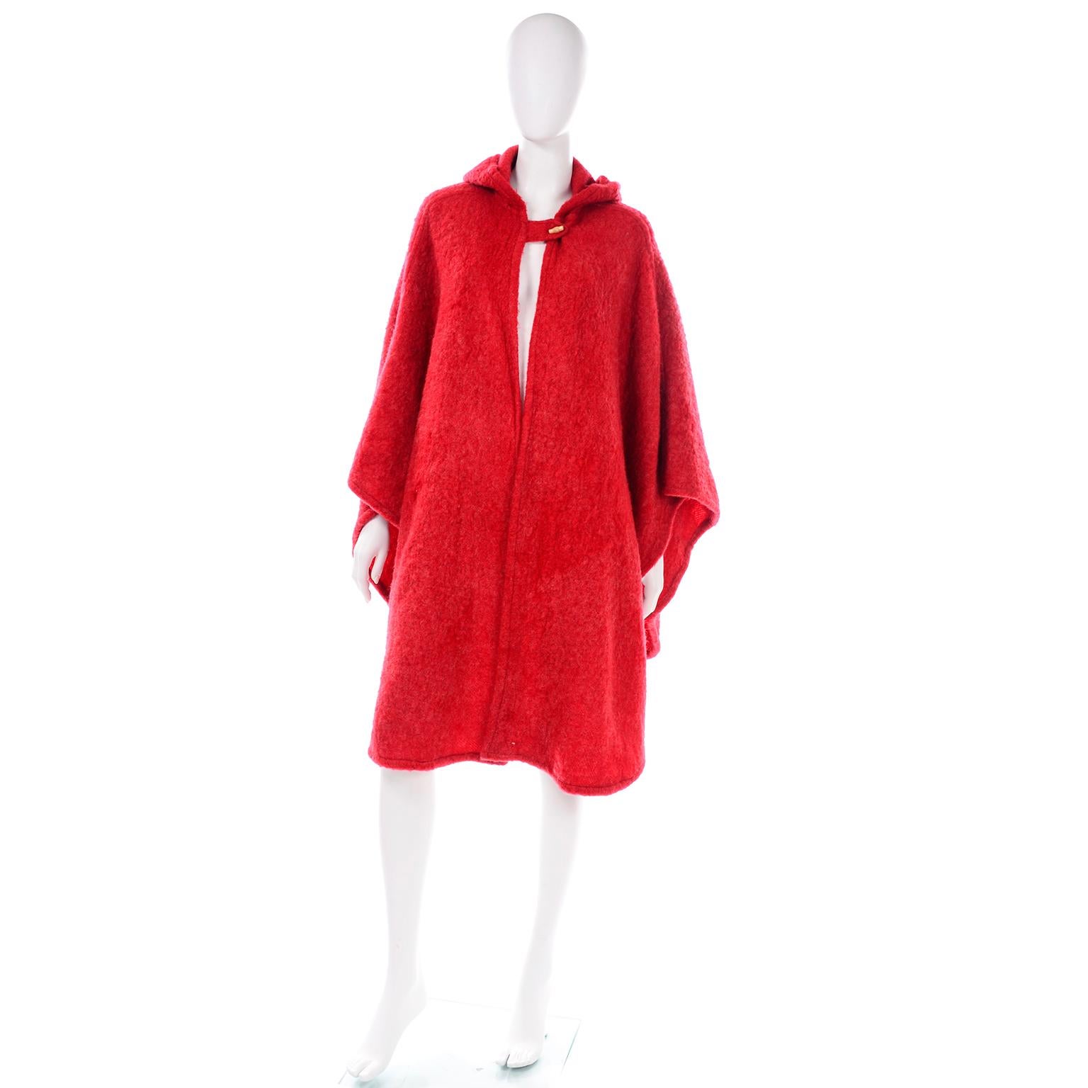 This is a late 1970's or early 1980's gorgeous rich red mohair blend cape with a hood from Anne Klein for Robinson & Golluber.  The cape closes at the neck with a single wood button and is perfectly on trend for this Fall and Winter.  The cape is in