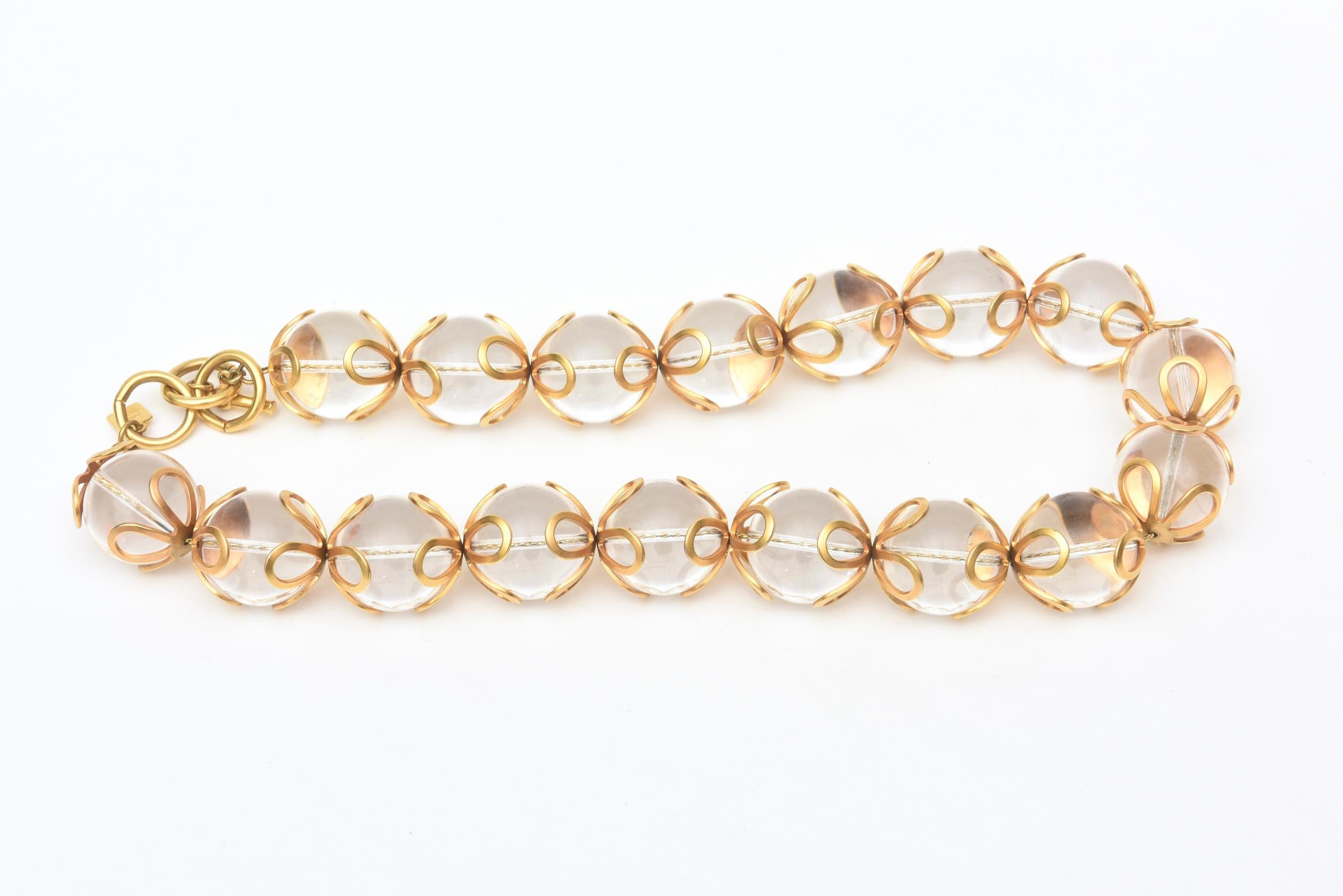 This great original vintage Anne Klein chunky lucite ball and gold filed embellished loop design necklace is from when Anne Klein was still living designing  jewelry. The series of loops surround the top and bottom of each lucite ball. It is from