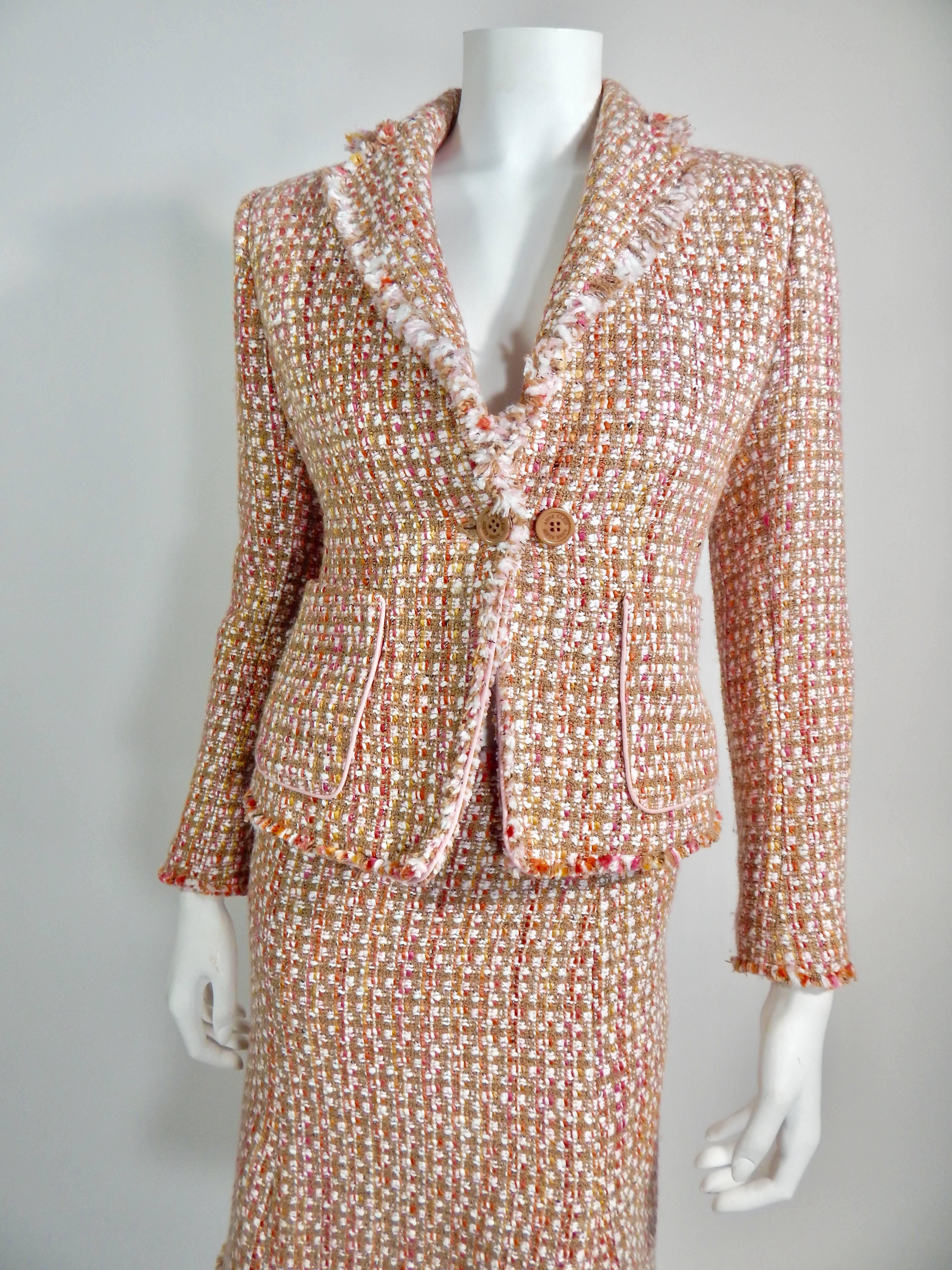 Anne Klein Suit with Skirt and Jacket / Blazer.  Tweed, pink, tan and white. Tan button closure on and front pockets on jacket. Zipper on skirt. Both jacket and skirt fully lined. Size 2.
