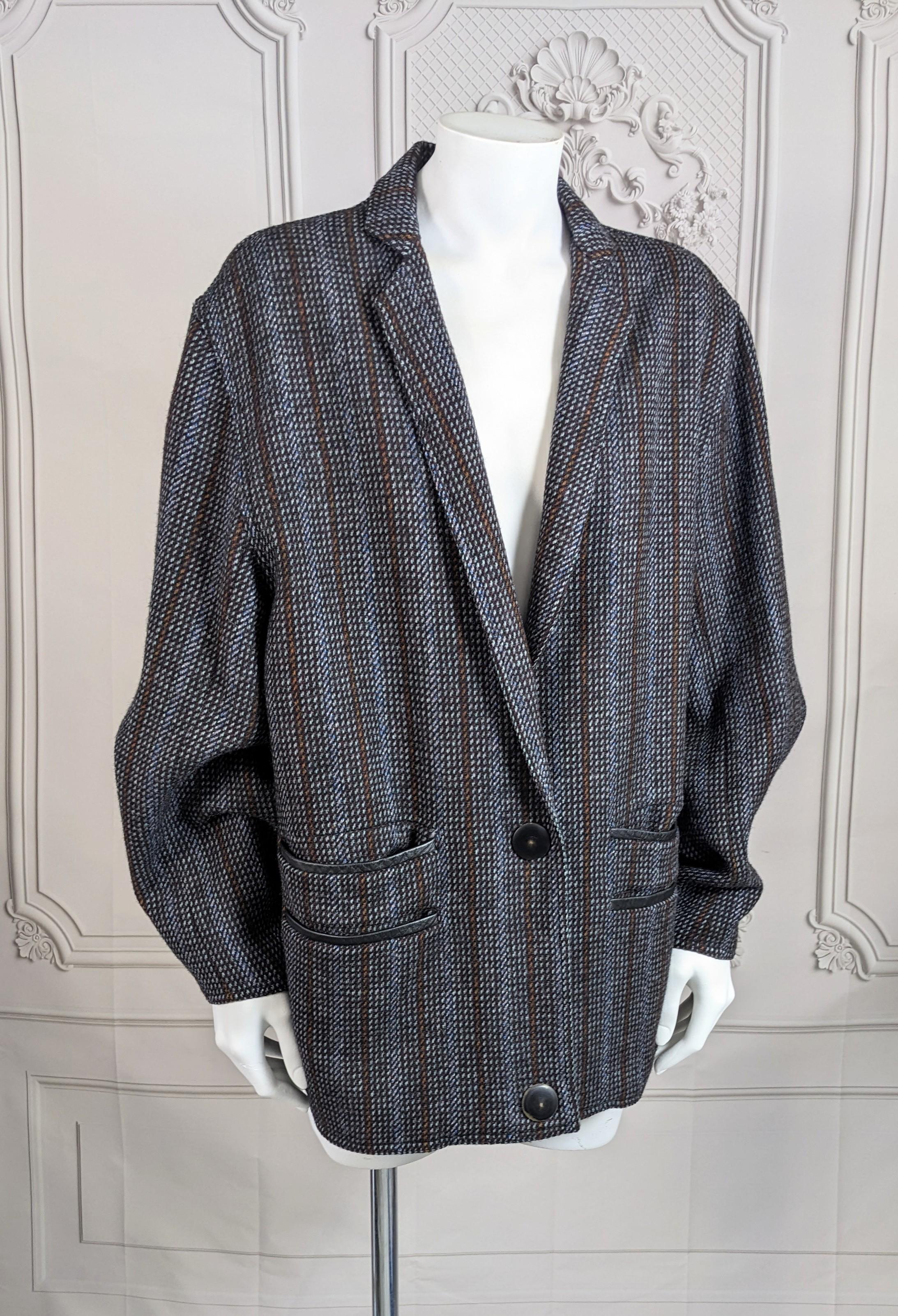 Iconic design by Anne Marie Beretta from the mid 1980's. Sculpted Tweed Jacket with signature angle sleeves and faux horn snap closure. Straight boxy cut with 2 sets of leather trimmed pockets. Fully lined. 
1980's France. 
Length 28