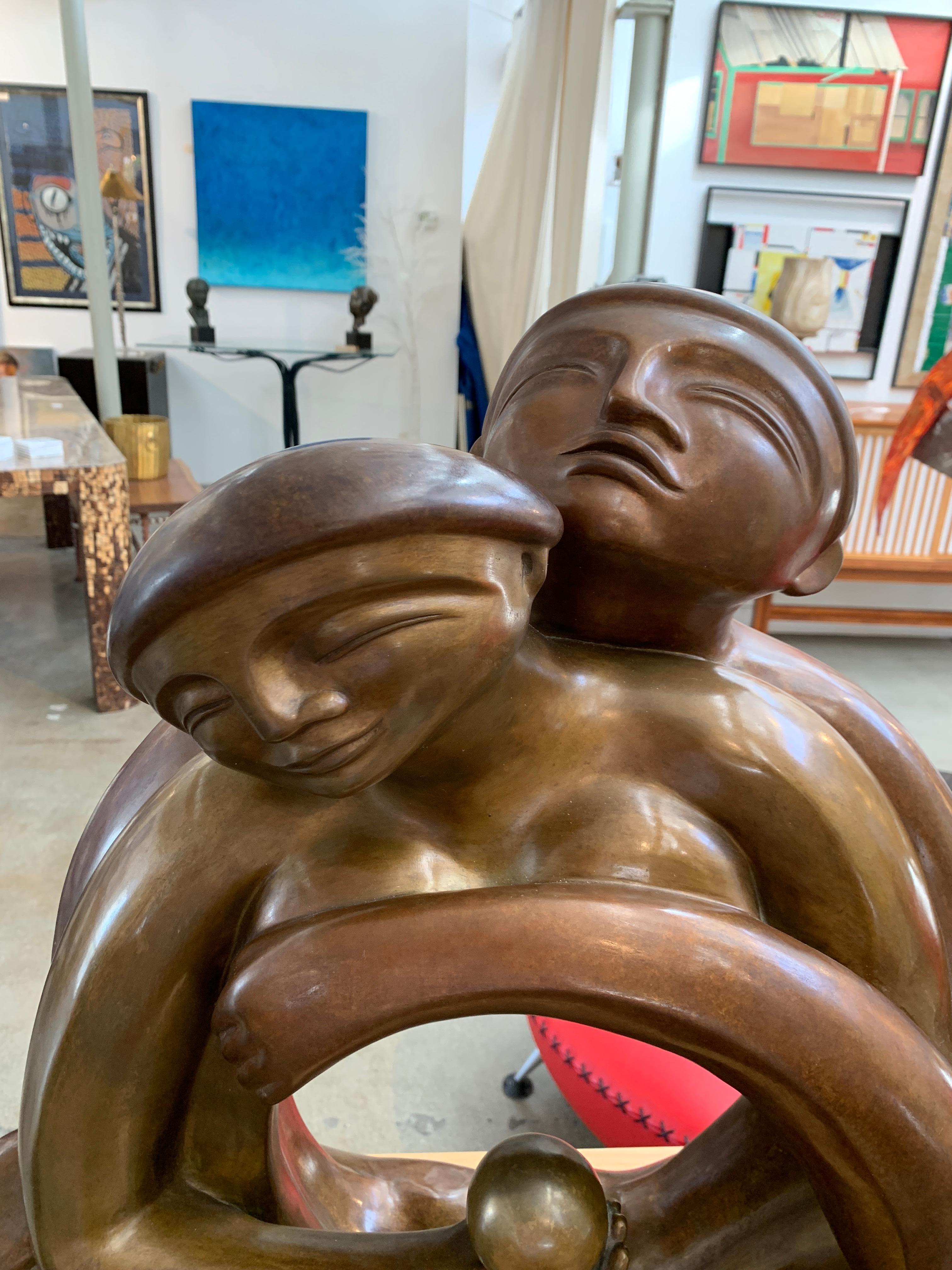 A large and quite lovely bronze by the noted French artist Anne Marie Paul (1949-2005). This piece is signed AM Paul and numbered 2/100 with a foundry mark. This is a substantial and large piece. Depicting a couple embracing. In good condition with