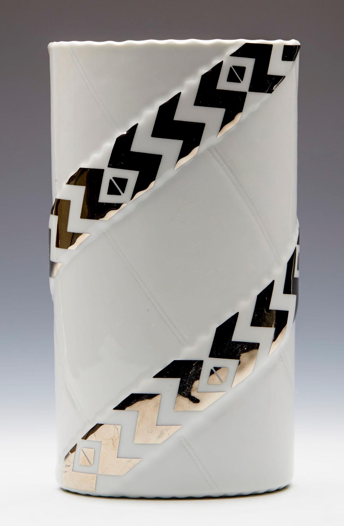 A very stylish Danish Royal Copenhagen Zenit pattern ceramic art vase designed by Anne-Marie Trolle (b. 1944) and dating from around 1980. The vase is of tall oval shape standing on an unglazed oval shaped base with hand applied designs. The body is