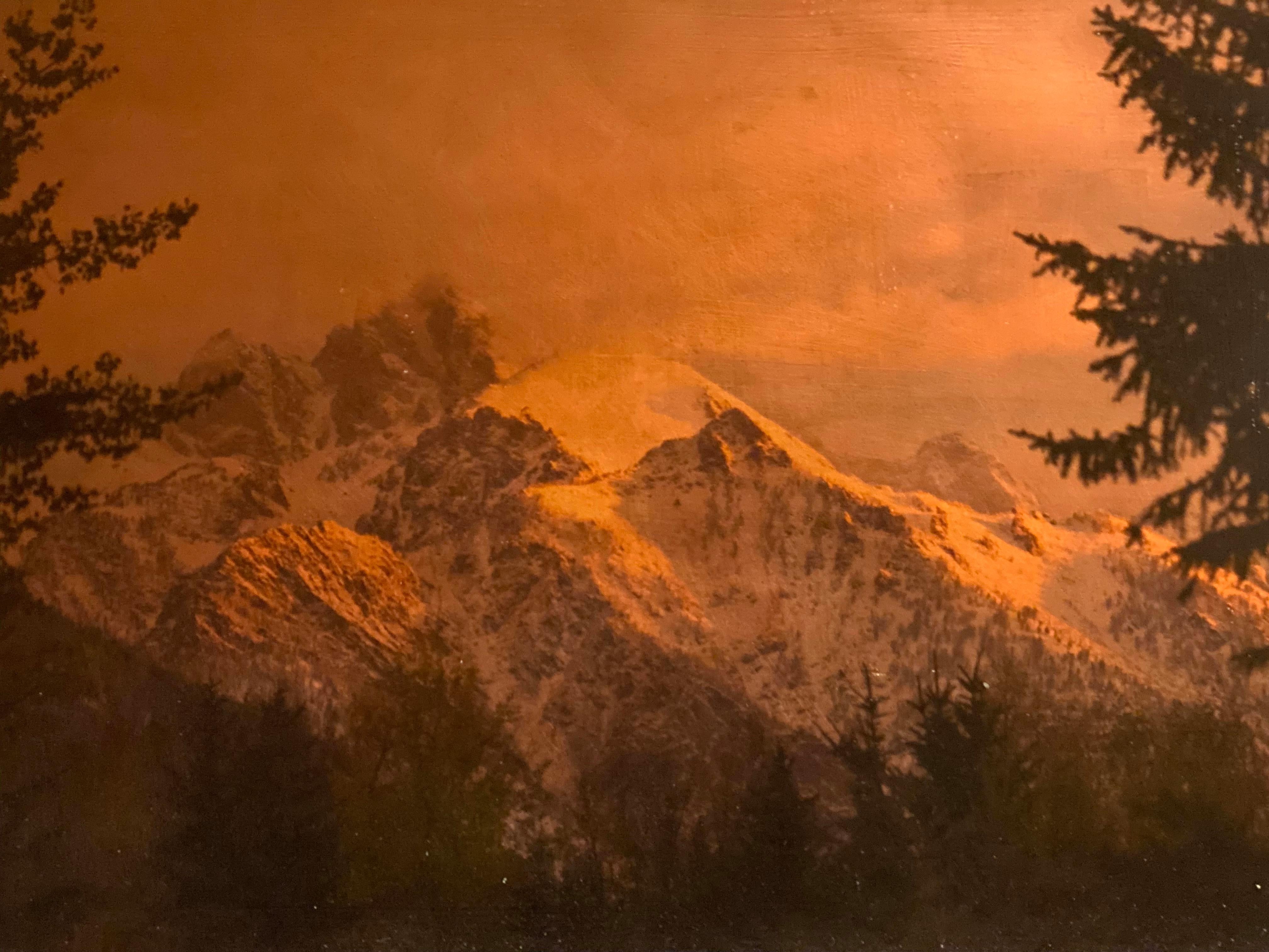 A horizontal photographic print on copper leaf and paper depicting a towering mountain peak by Anne Muller. Muller combines her photography skills with her experience in painting and textiles as she renders this stunning landscape image in the