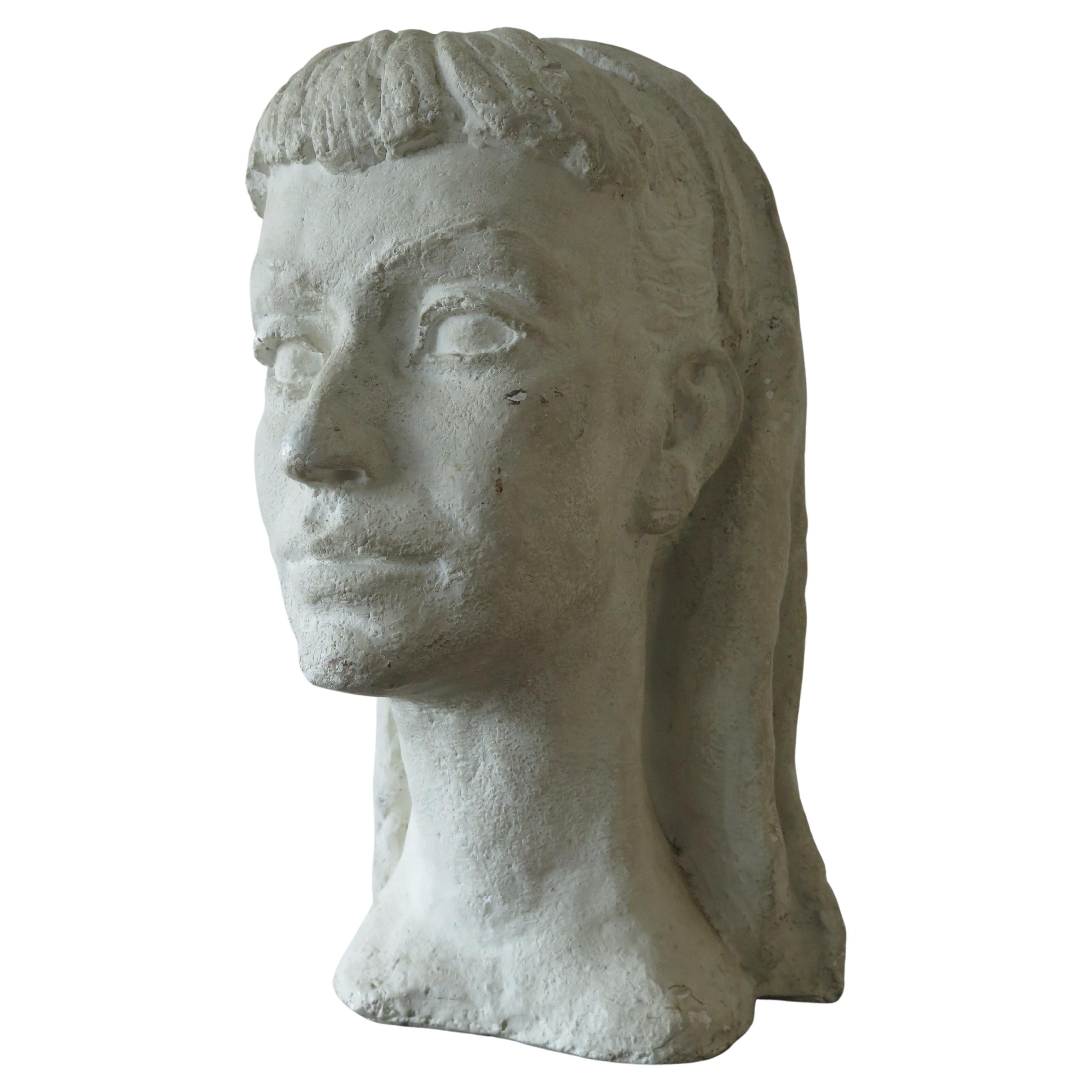 A beautiful, stylized bust by Anne Van Kleeck, circa 1950s. Plaster, heavy, this unique sculpture has a real mid-century feel and timeless presence. From the artist's estate. 
A note about the artist: Anne Van Kleeck was primarily known for her