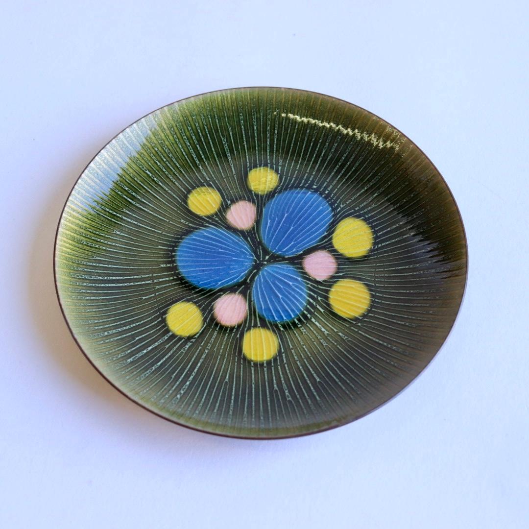 This is a gorgeous dish by Annemarie Davidson.

This is an enchanting blue, green, pink and yellow enamel and copper dish in a starburst design. By Annemarie Davidson, a prominent Southern California artist, from Sierra Madre, near Pasadena. This