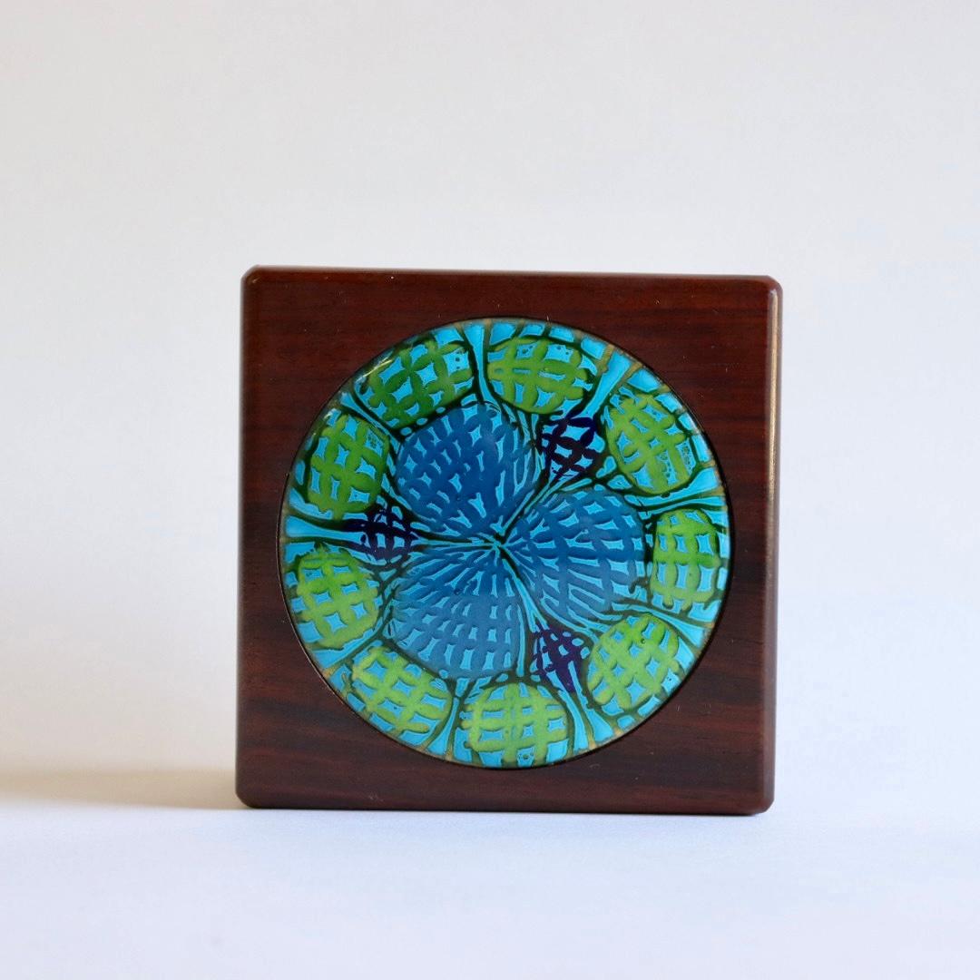 A rarely seen rosewood box with an enchanting blue, green, and gold enamel and copper inlay with a starburst design. Annemarie Davidson was a prominent and beloved Southern Californian artist, from Sierra Madre, near Pasadena. Rarely seen rosewood