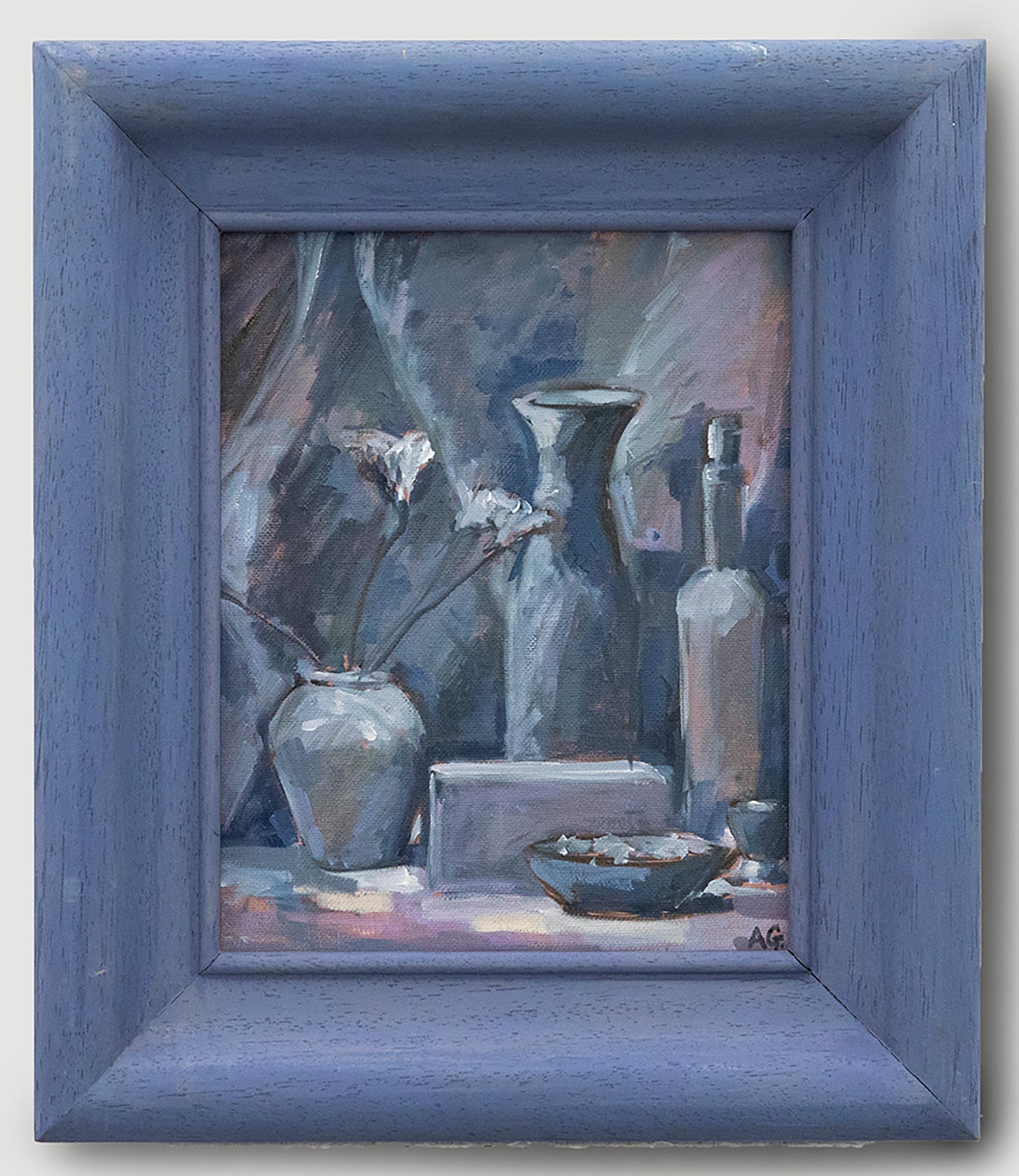 A charming still life study depicting ceramics painted in shades of blue. Signed to the lower right with initials. Presented in a blue painted frame. On canvas board.