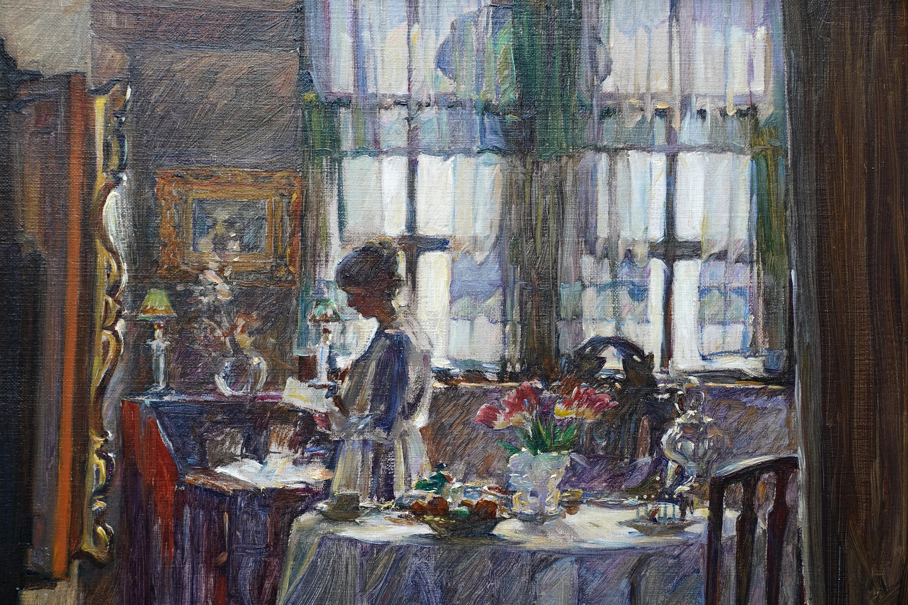 This superb Scottish Edwardian  Impressionist interior oil painting is by noted Scottish female artist Annie Rose Laing. Painted circa 1910, the composition is the interior of a room with a lady stood between a table and writing desk, reading a