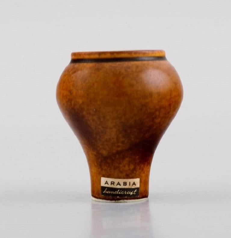 Annikki Hovisaari (1918–2004) for Arabia. Miniature vase in glazed ceramics. 
Beautiful glaze in brown shades. 1960's.
Measures: 5.2 x 4.8 cm.
In excellent condition.
Stamped.