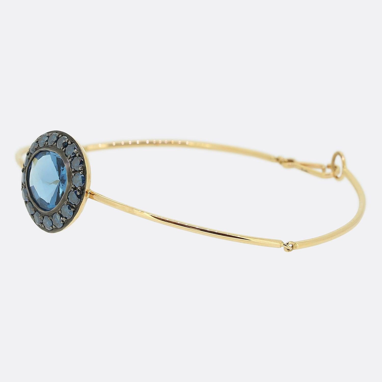 Here we have beautiful gem set bracelet from the world renowned jewellery designer, Annoushka.  Set on a delicate rose gold bracelet, the Dusty Diamonds Topaz bangle features a deep, rich London blue topaz surrounded by a halo of round faceted blue