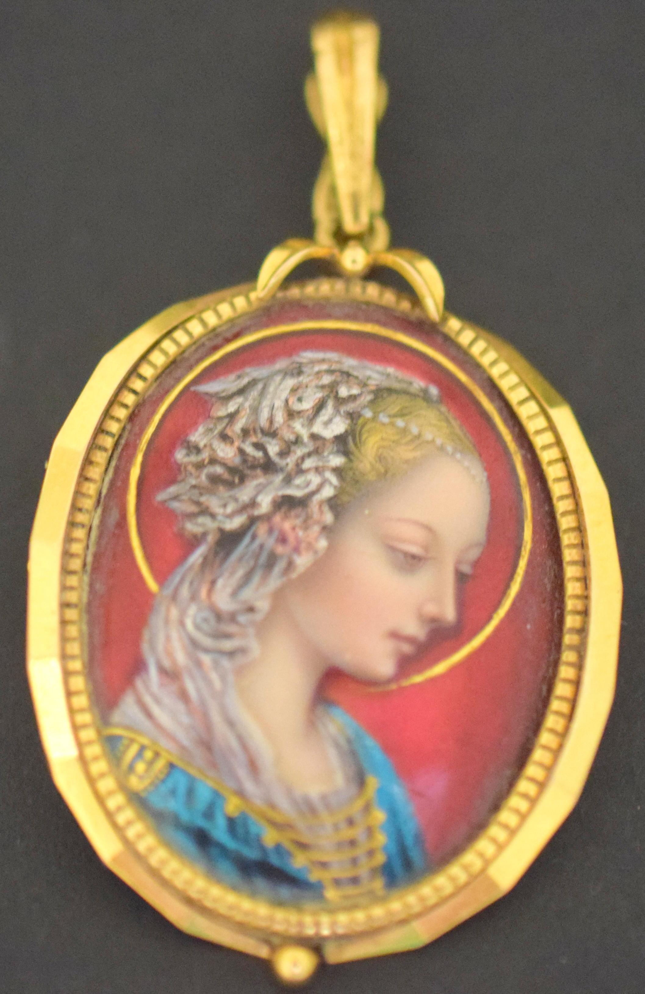 Amazing quality on this annunciation virgin enamel portrait of a lady. This pendant is crafted in 18k yellow gold, with hot enamel used to create the portrait. Colors pop on this piece showing red, blue and silver. Exquisite details are shown on