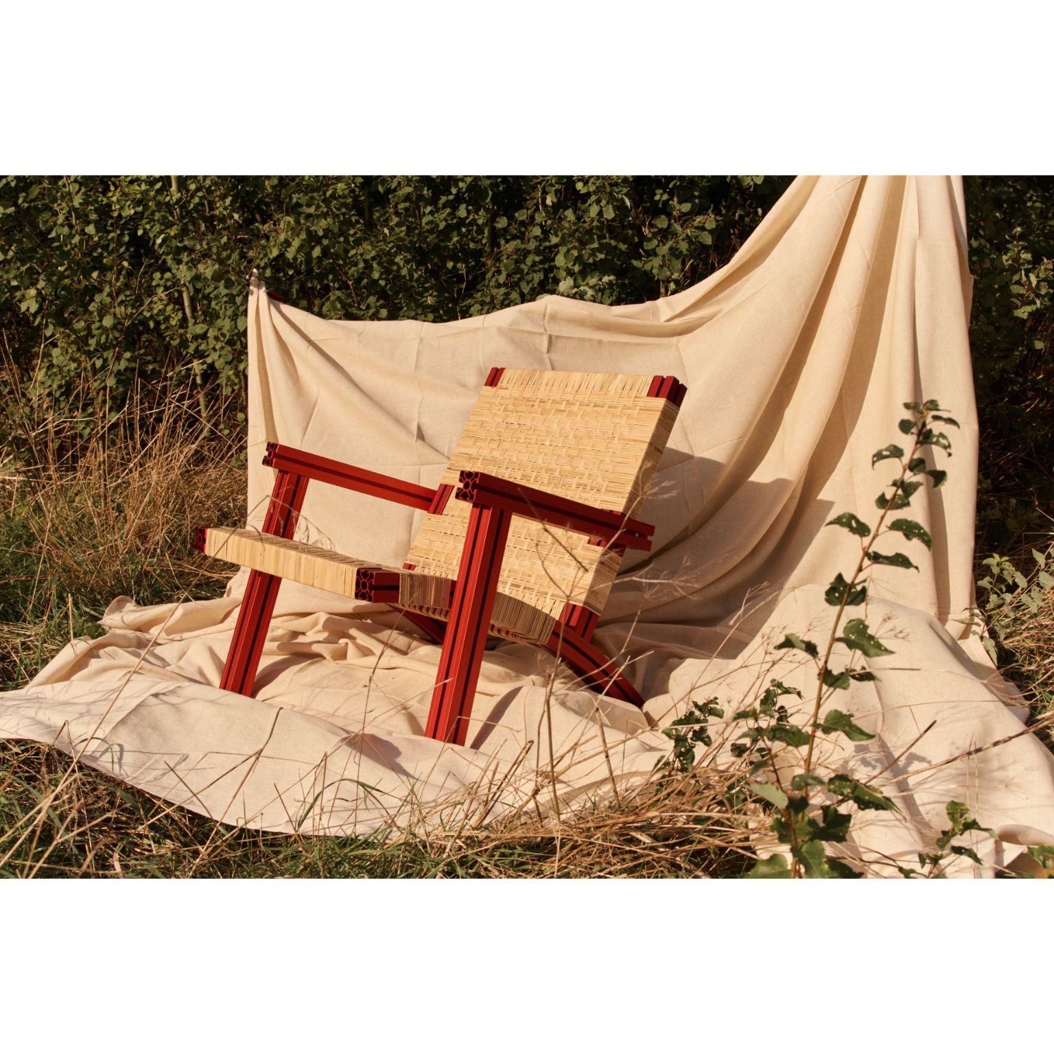 British Anodized Burgundy and Cane Wicker Armchair by Tino Seubert For Sale