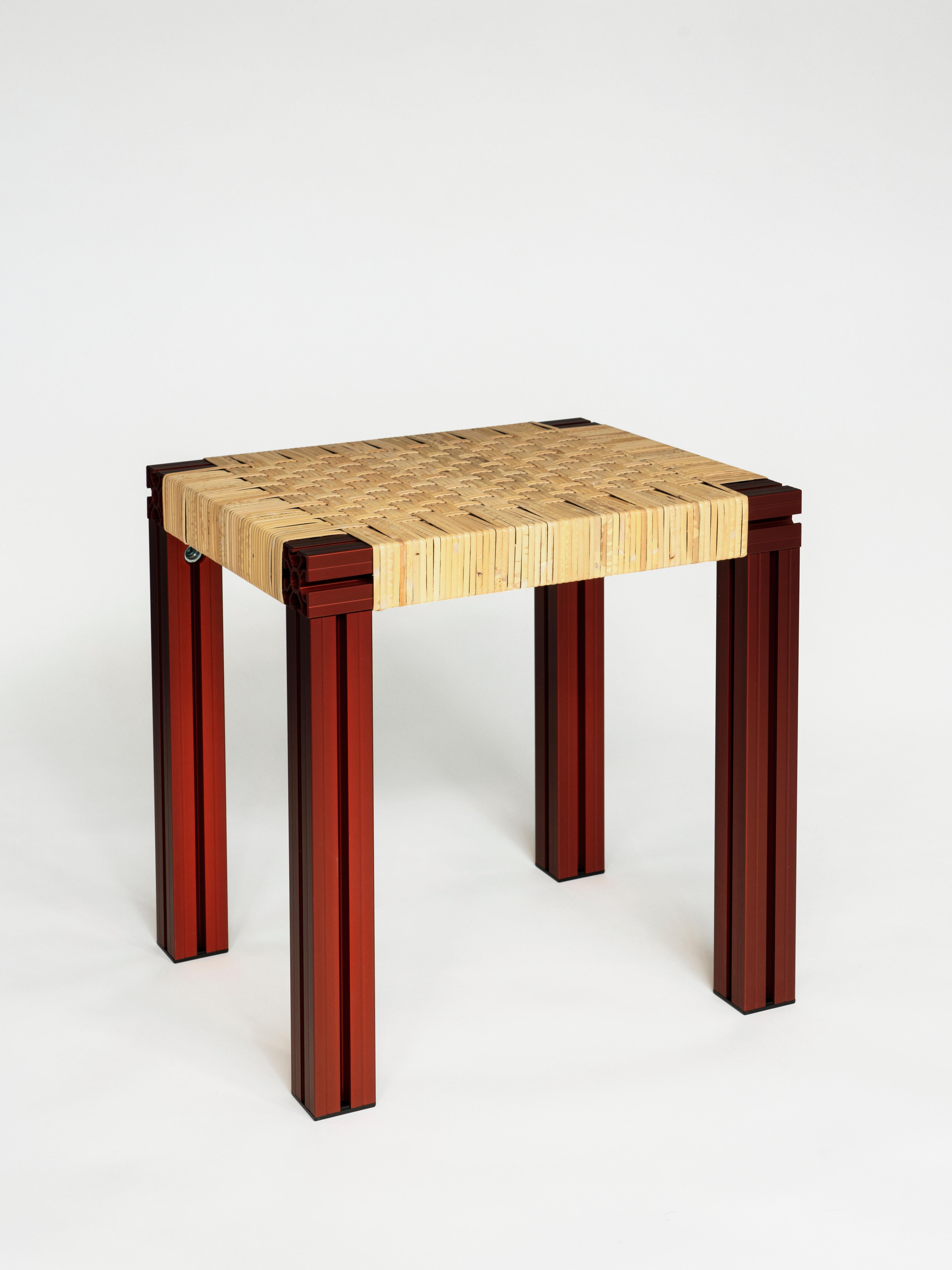 Anodised Burgundy and Cane wicker stool by Tino Seubert
Dimensions: D 43 x W 38 x H 45 cm.
Materials: Color anodized aluminum extrusions, cane weave.

Tino Seubert
When he first made his now signature wicker and aluminium stools and benches in