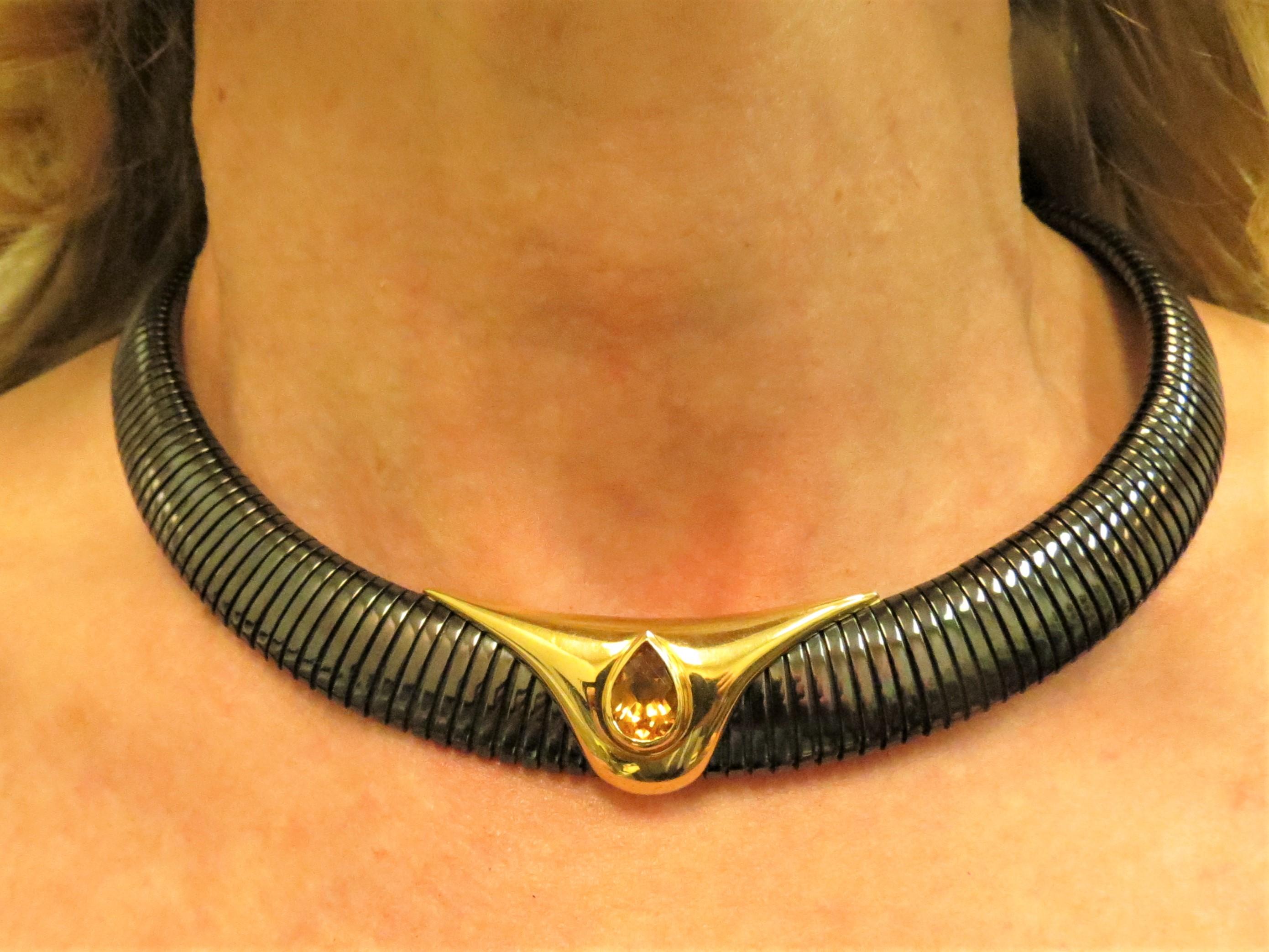 Anodized ribbed steel necklace which is flexible but conforms to the neck with 18 K yellow gold overlay, bezel set in center with 4.01ct pear shape faceted Citrine
Last retail. $3500