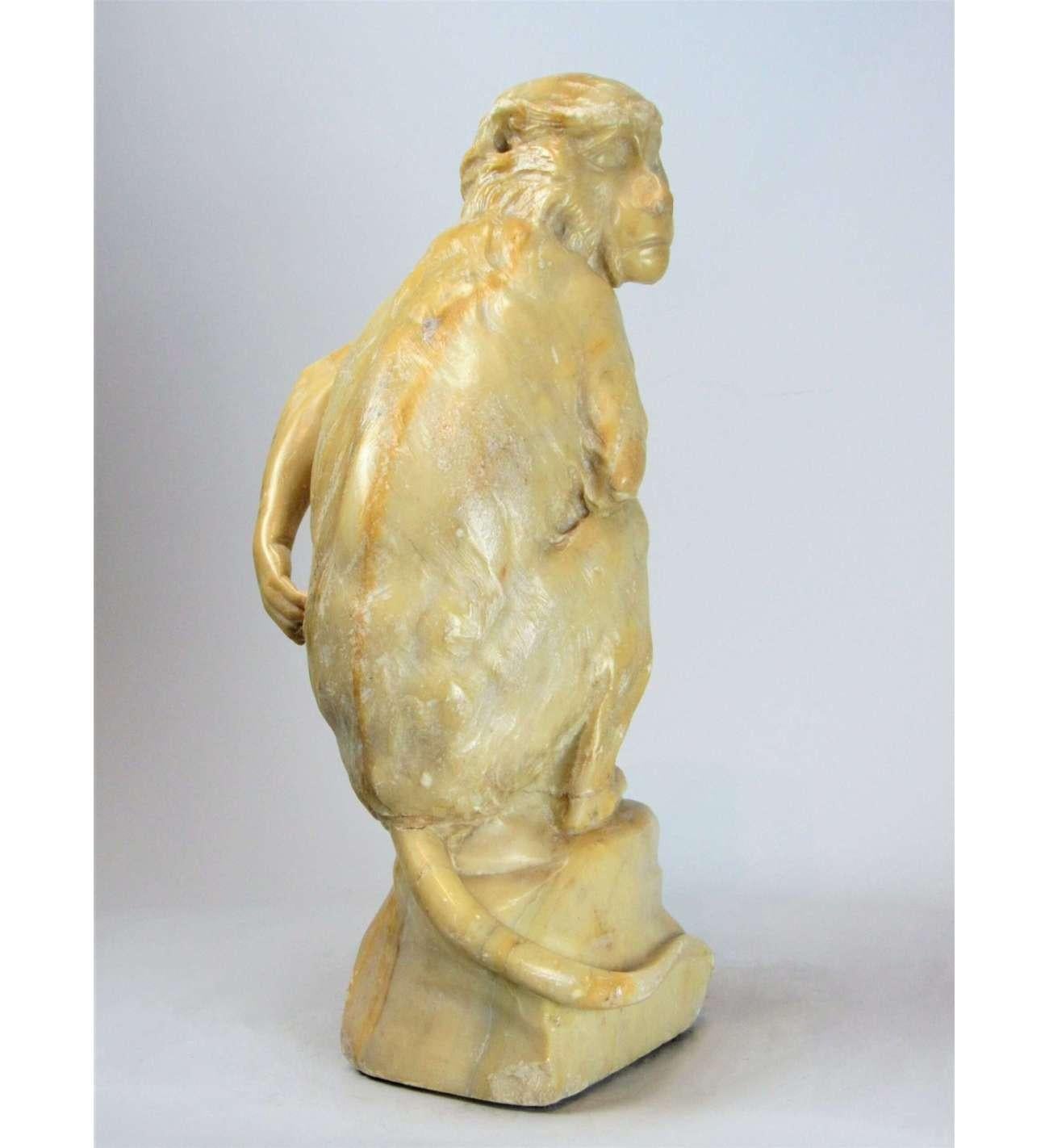 A frightened monkey looking sideways, carved in yellow (Sienese?) marble. Origin Italy. First half of the nineteenth century.